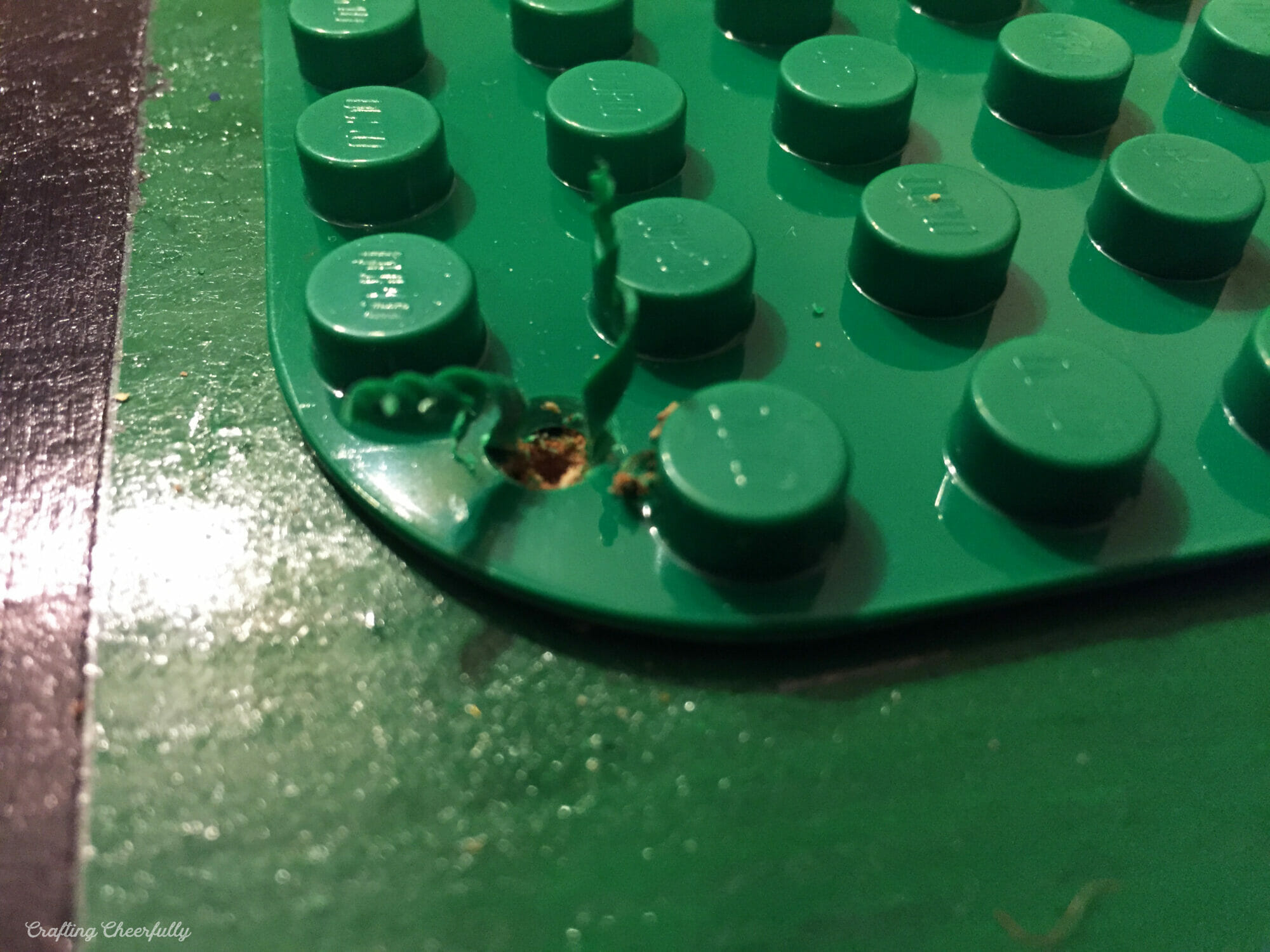 Spirals of plastic come out of the drilled hole.