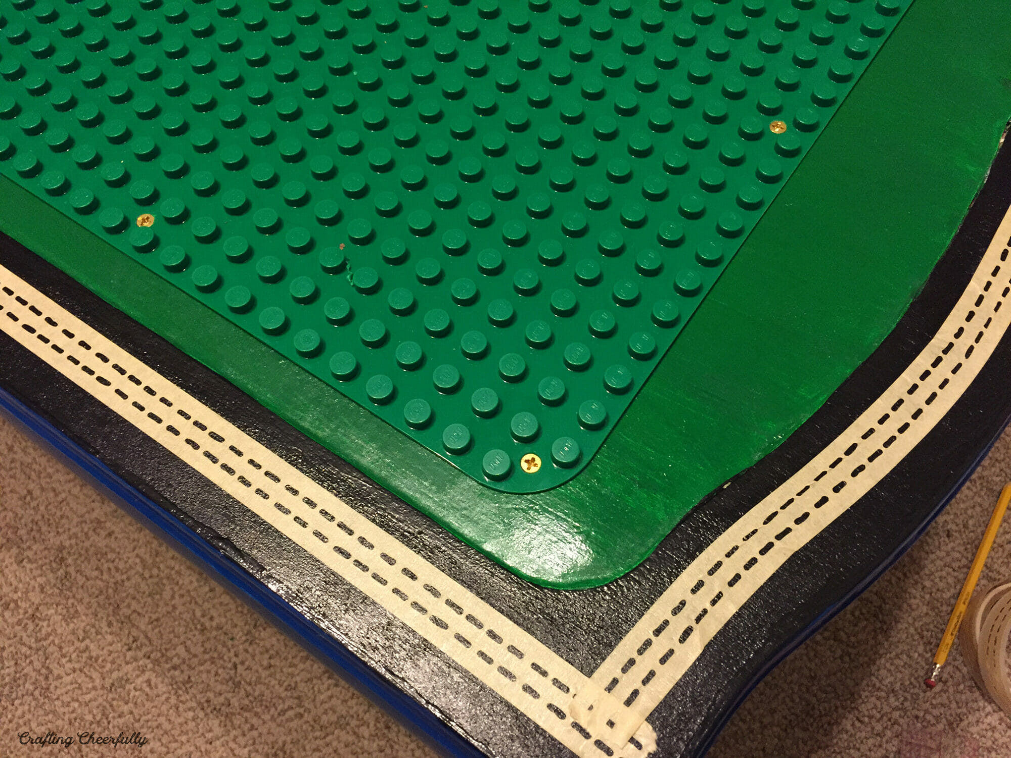 Tape is attached along the black painted areas of the table.
