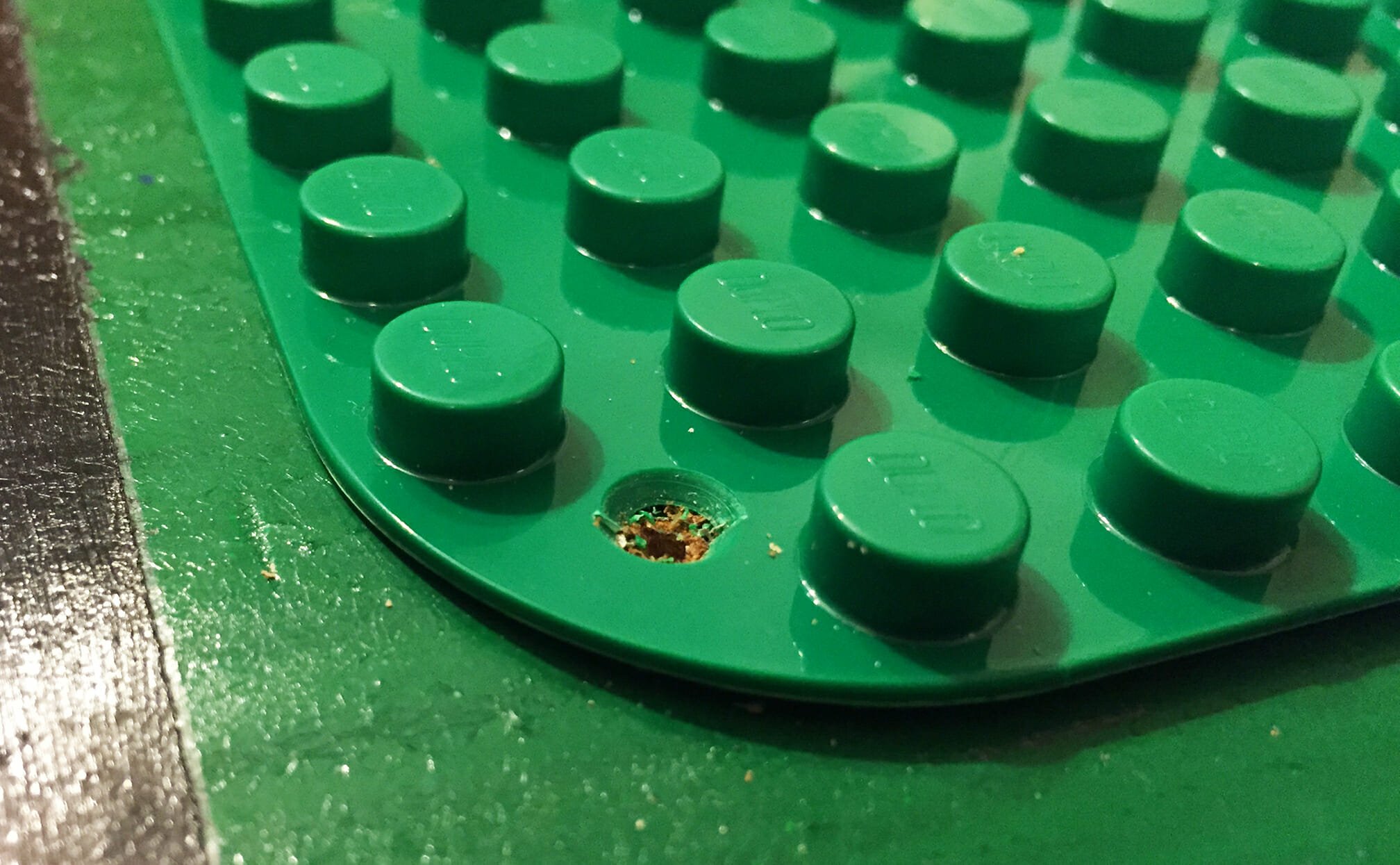 A hole has been drilled in the corner of the baseplate.