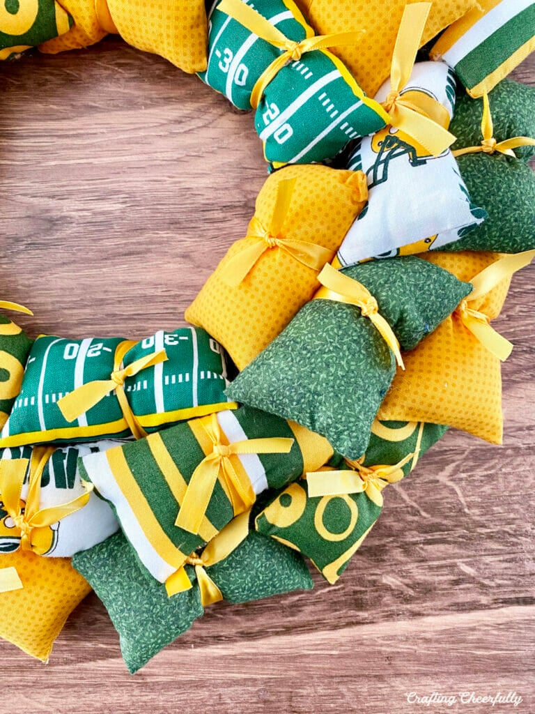 Football Pillow Wreath with Sports-themed pillows in green, yellow and white.