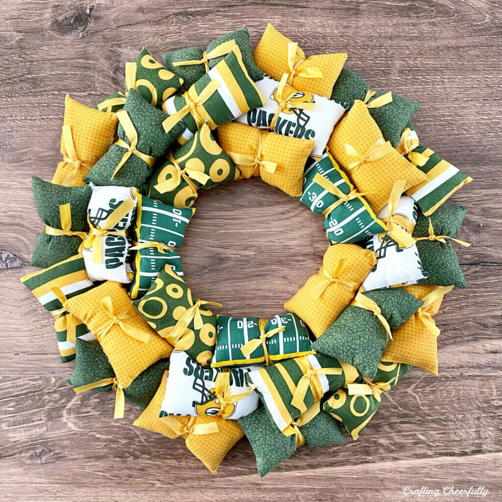 Green Bay Packers Football pillow wreath made from green, yellow and white mini pillows.