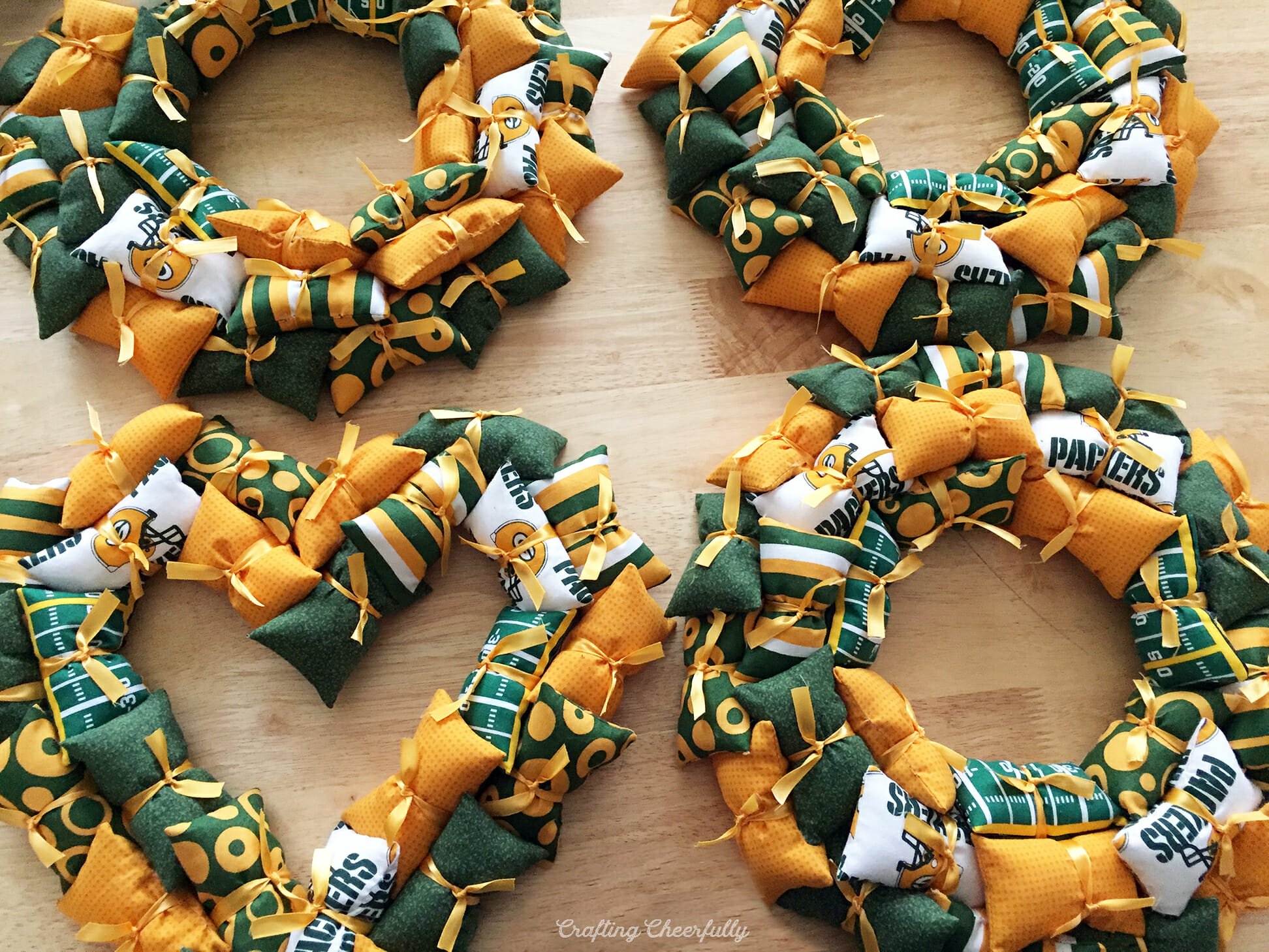 Four football wreaths made from tiny pillows in sports colors.