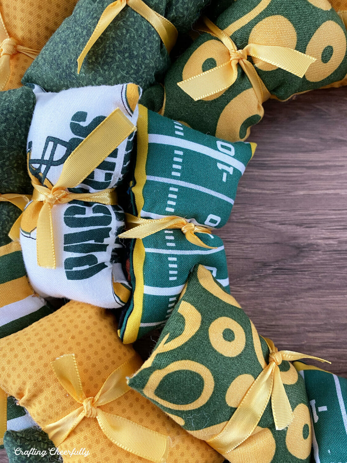 Football-themed fabric used for a sports team pillow wreath.