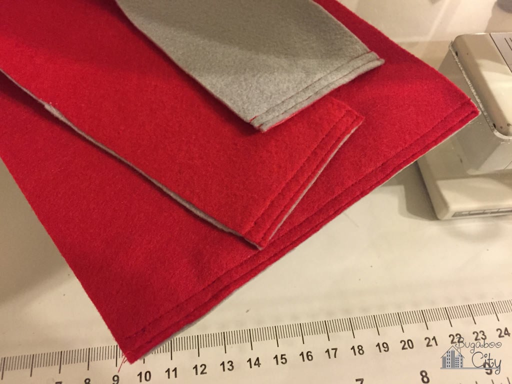 Pieces of red felt that have been stitched along the top edges.