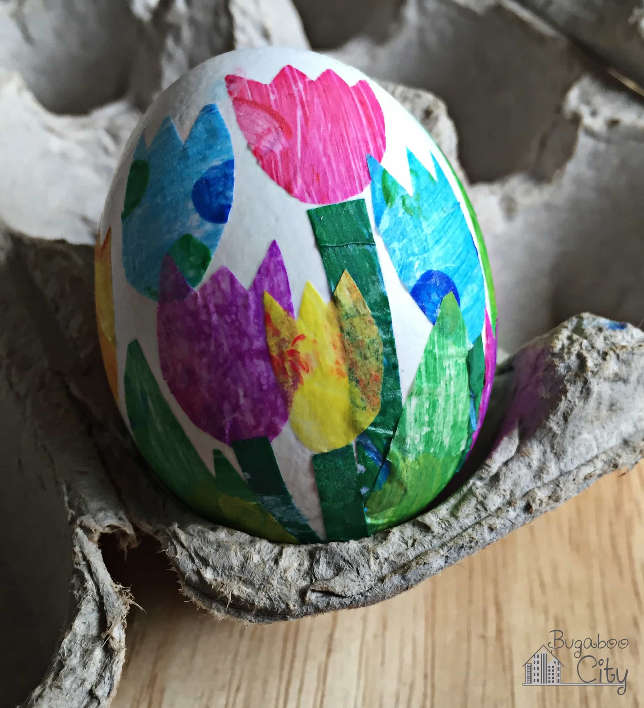 Egg decorated with tissue paper flowers.