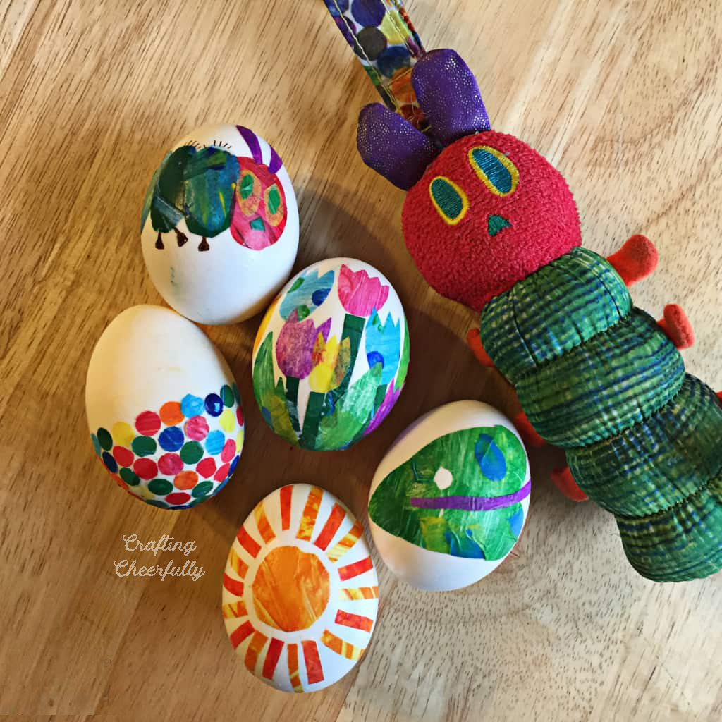 A Hungry Caterpillar toy lays next to tissue paper eggs.