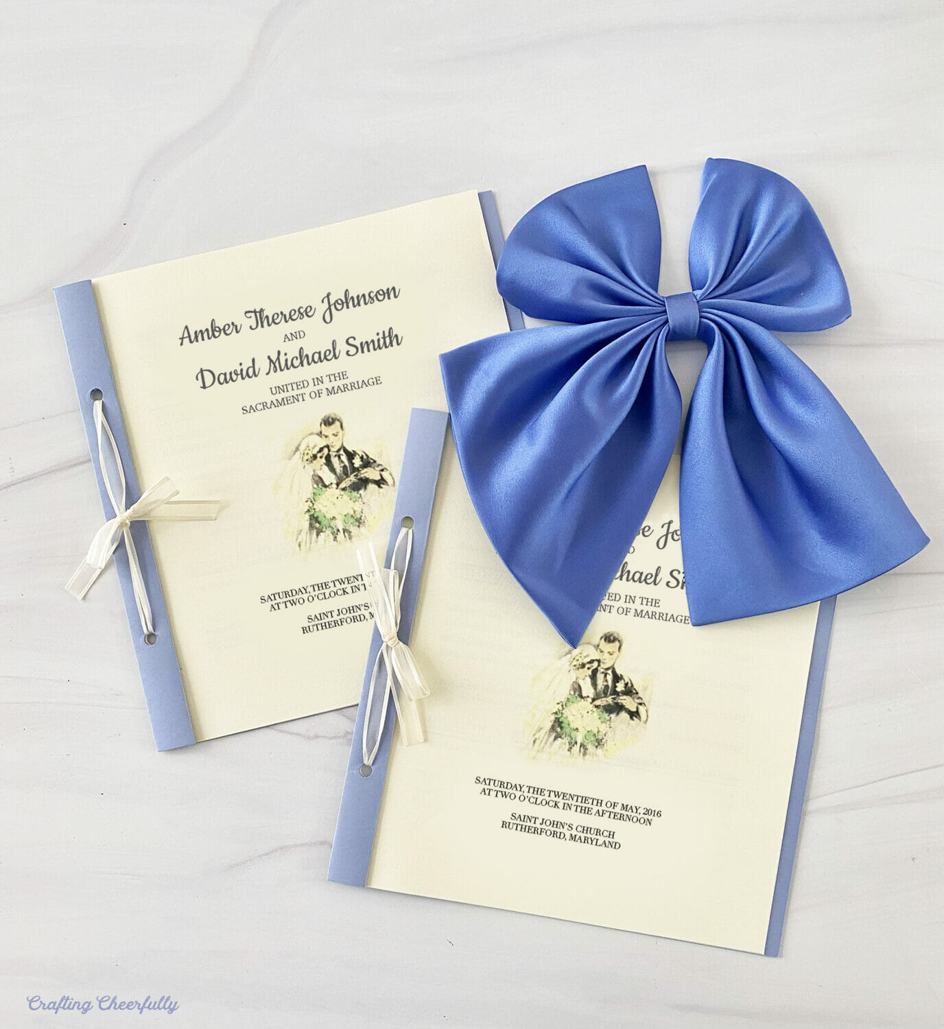 Two ceremony programs lay next to a periwinkle bow from a bridesmaid dress.