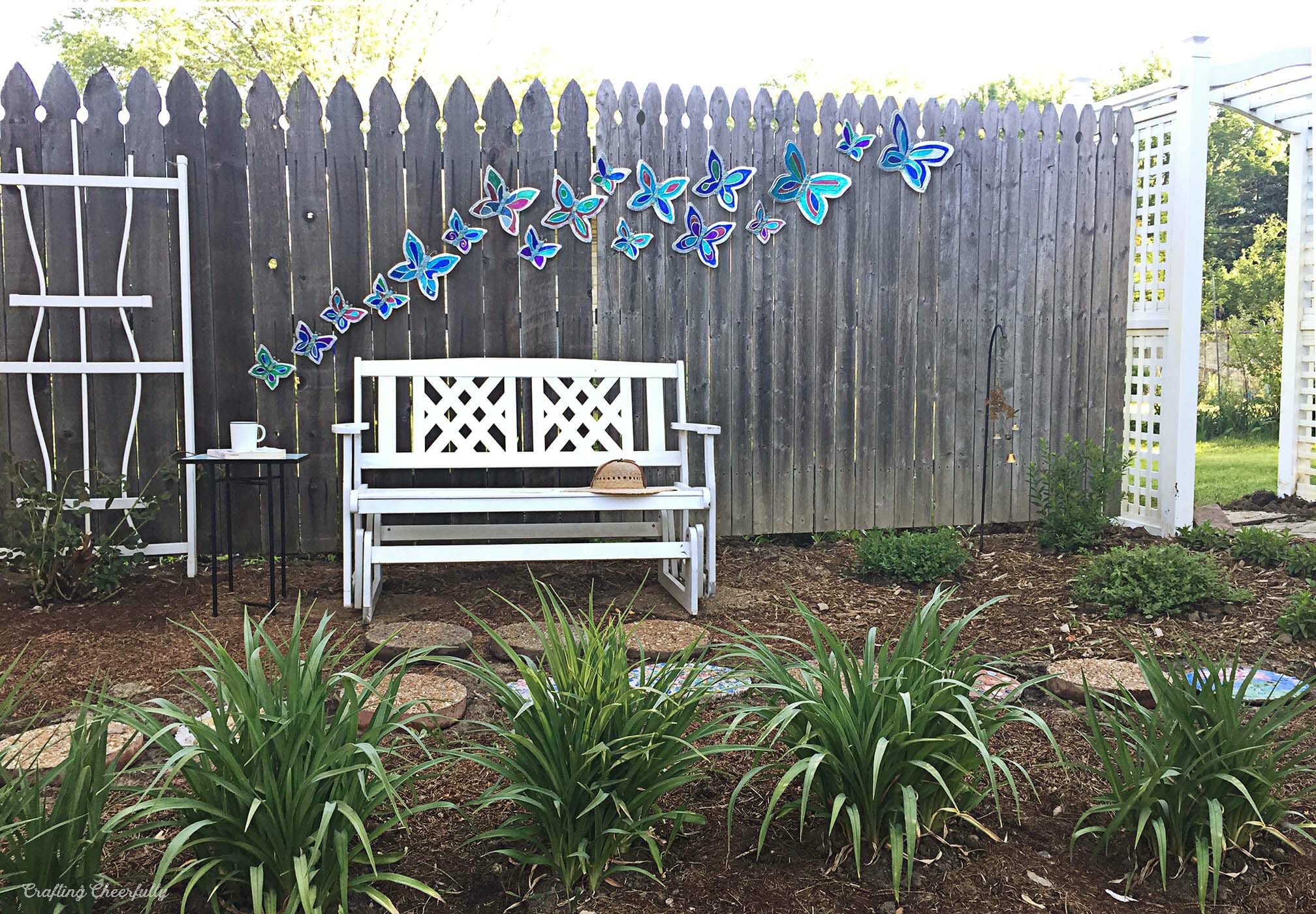 Handmade Butterfly garden ornaments arranged on a garden fence.
