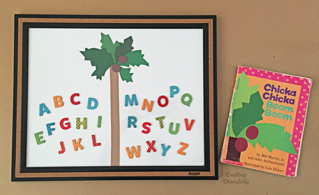 Dry Erase board with magnetic palm tree and letters lay next to the book Chicka Chicka Boom Boom.