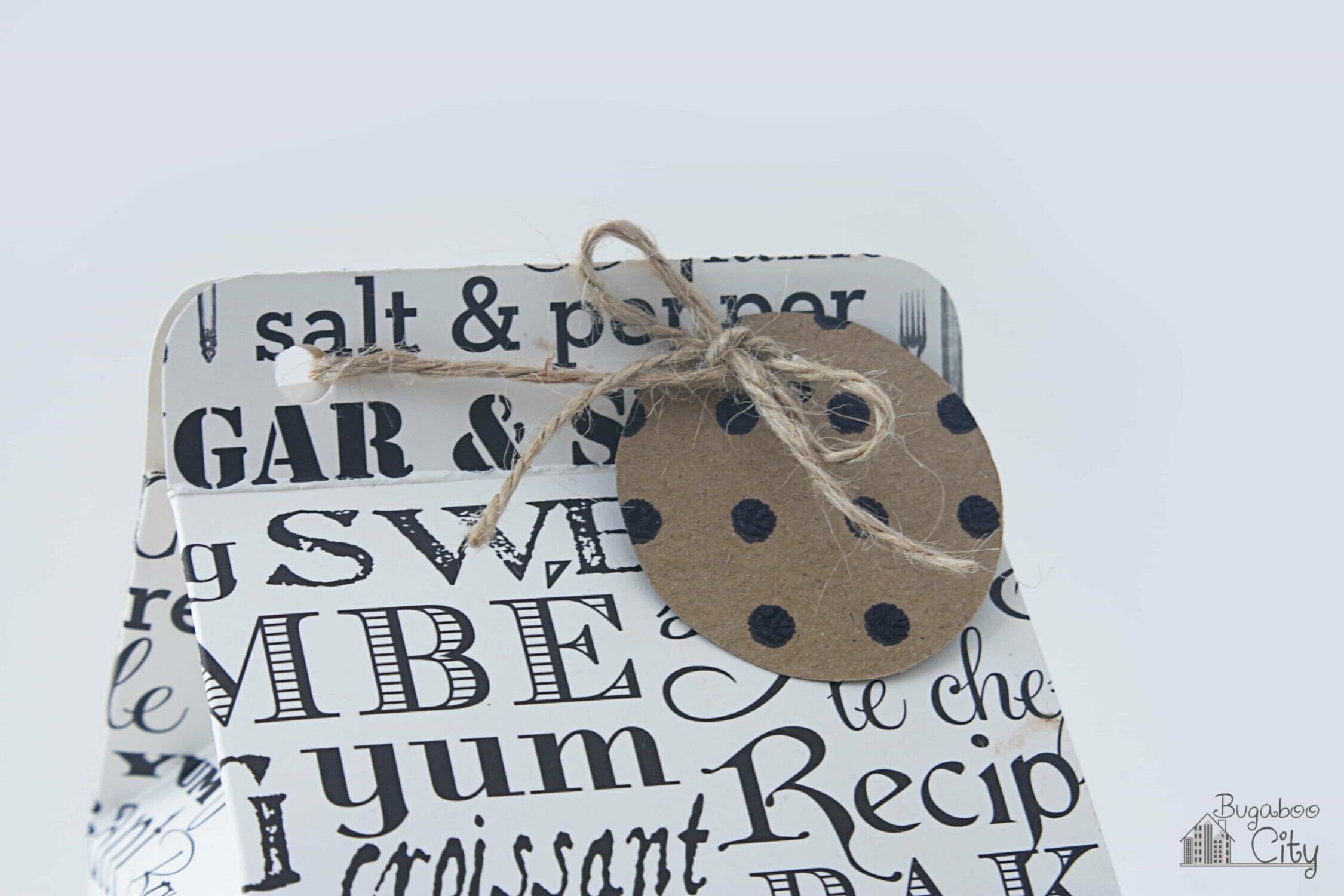 A cute circular gift tag that looks like a chocolate chip cookie is added to the top of the treat box.