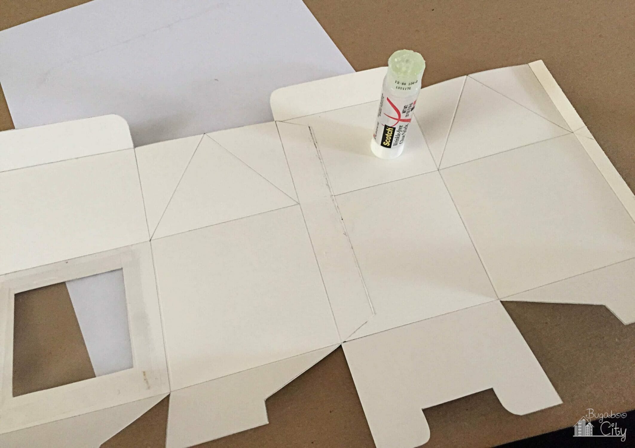 The two box pieces are adhered along the tabs with a glue stick.