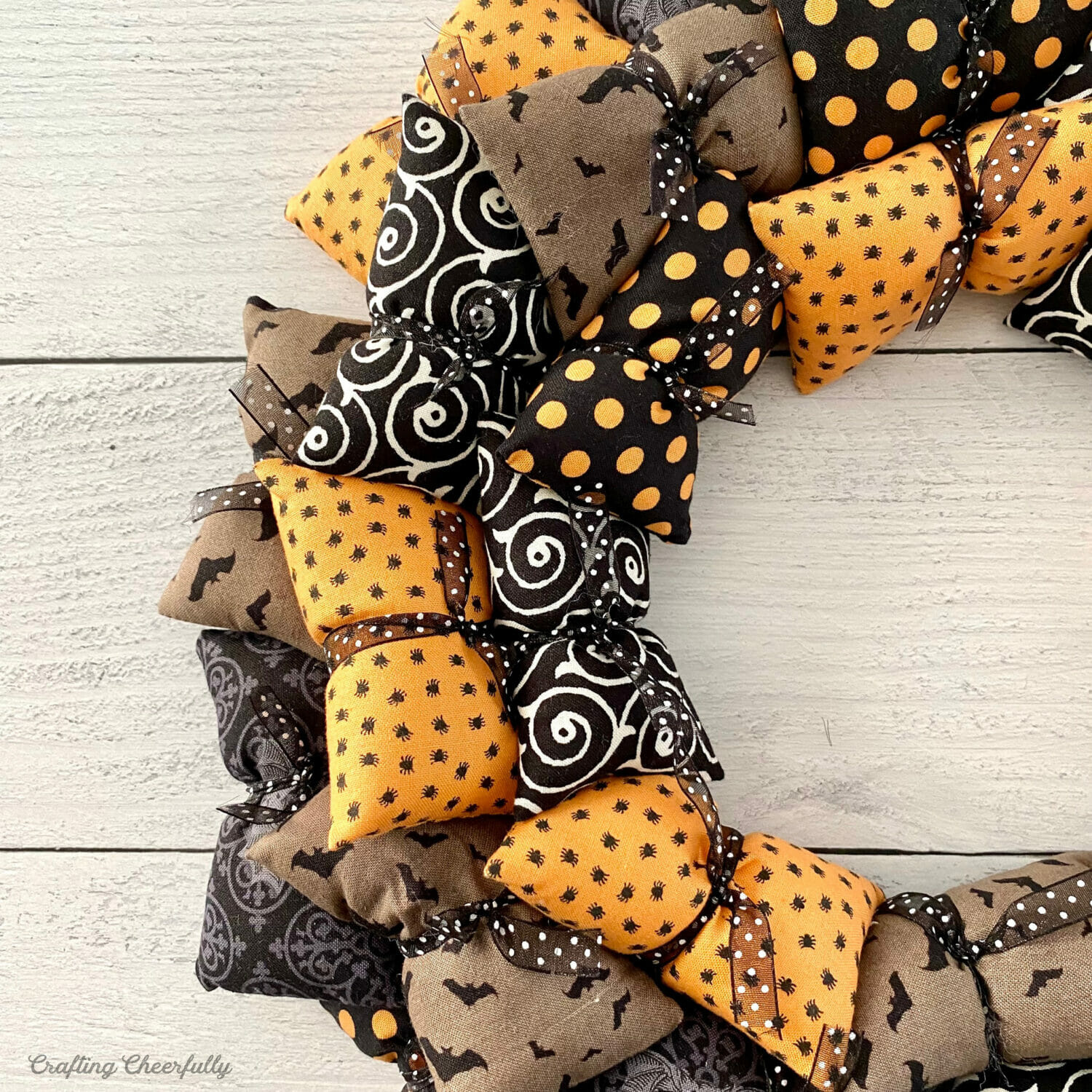 Halloween pillow wreath made from tiny pillows attached to the wreath frame with ribbon.