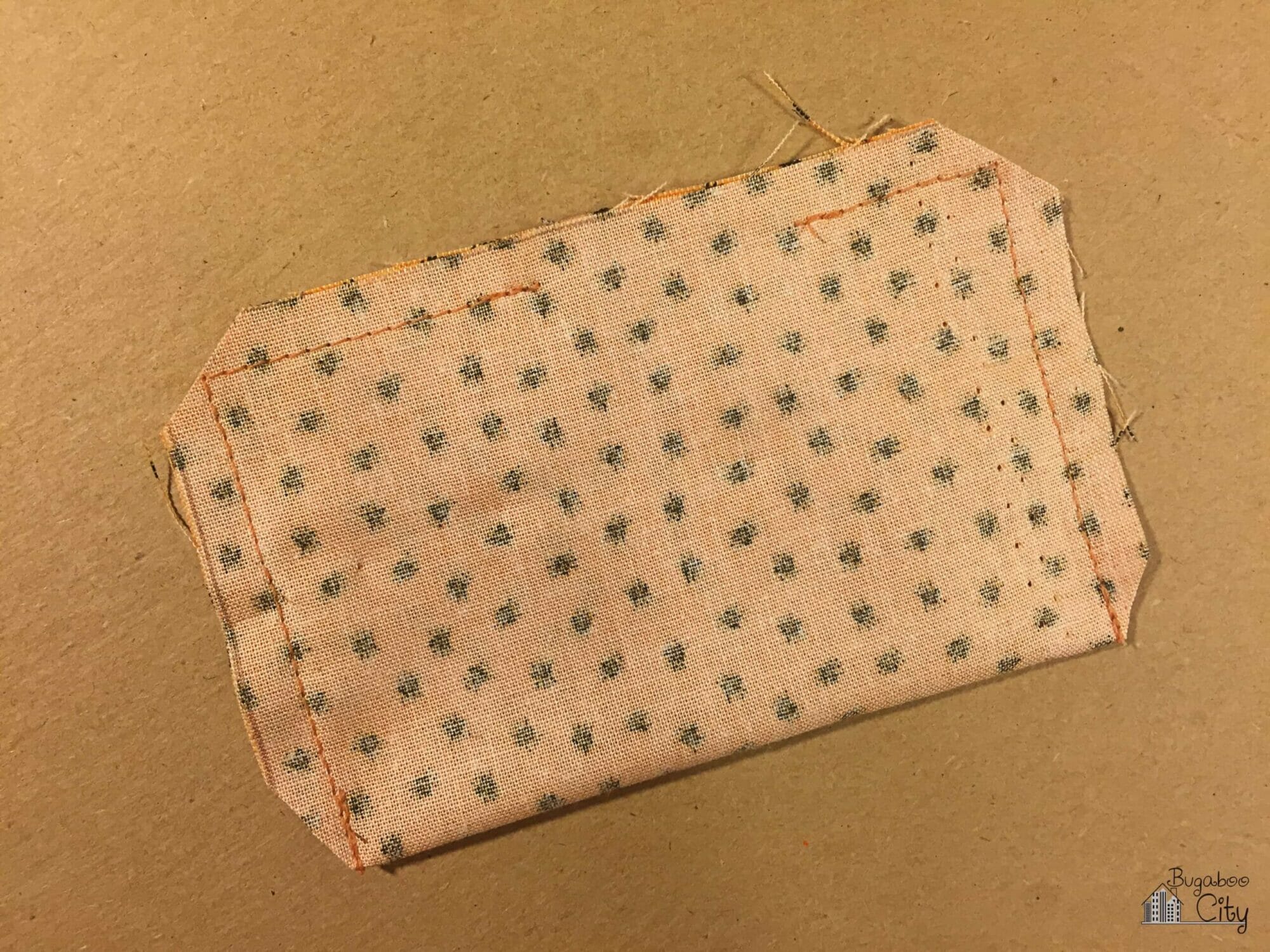 A fabric rectangle is folded in half and stiched around the edges leaving an opening along the long edge.