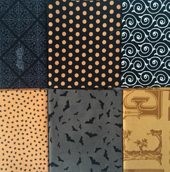Fabric fat quarters used to make the Halloween pillow wreath.