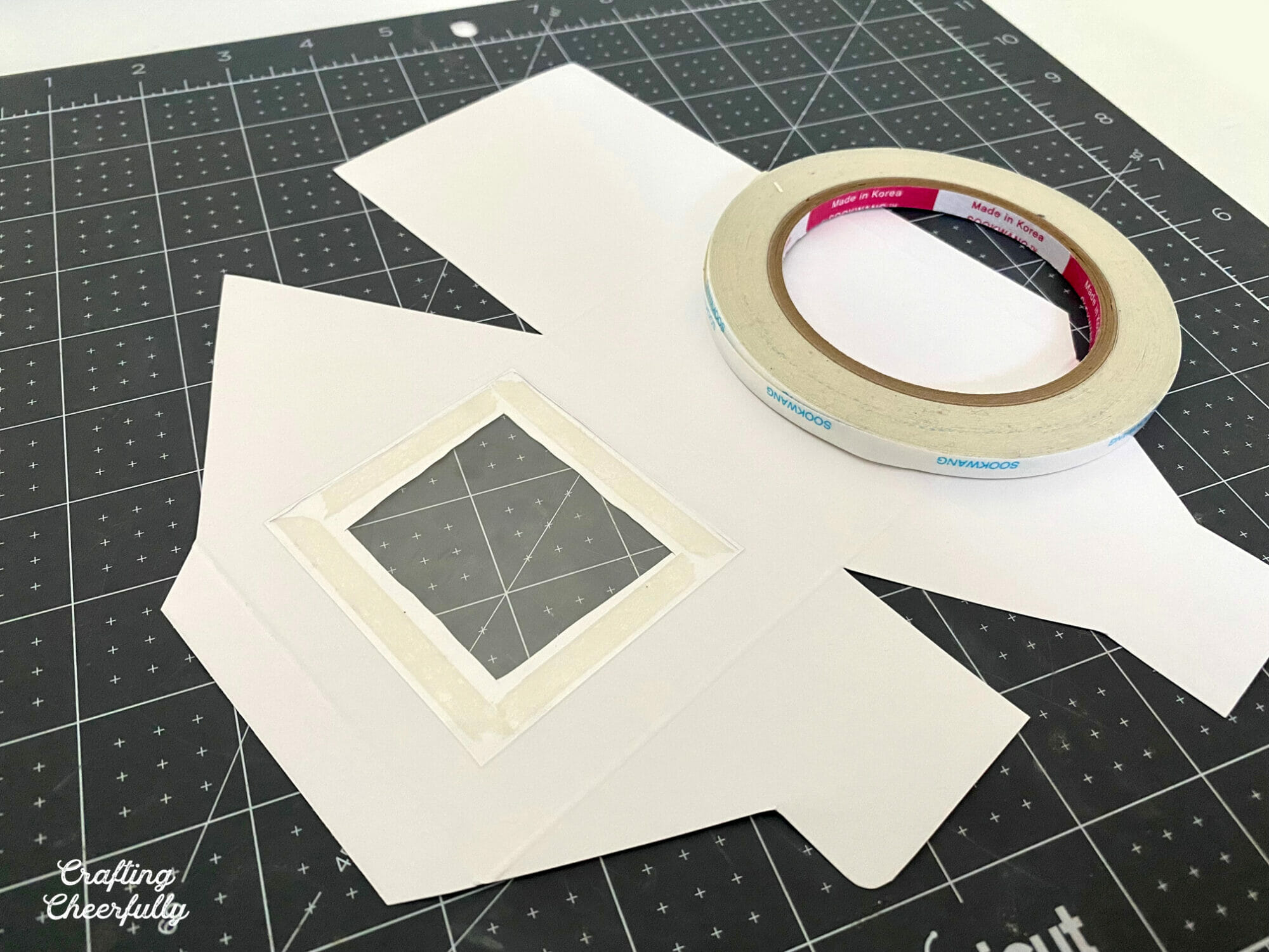 Treat box being assembled with double sided tape.