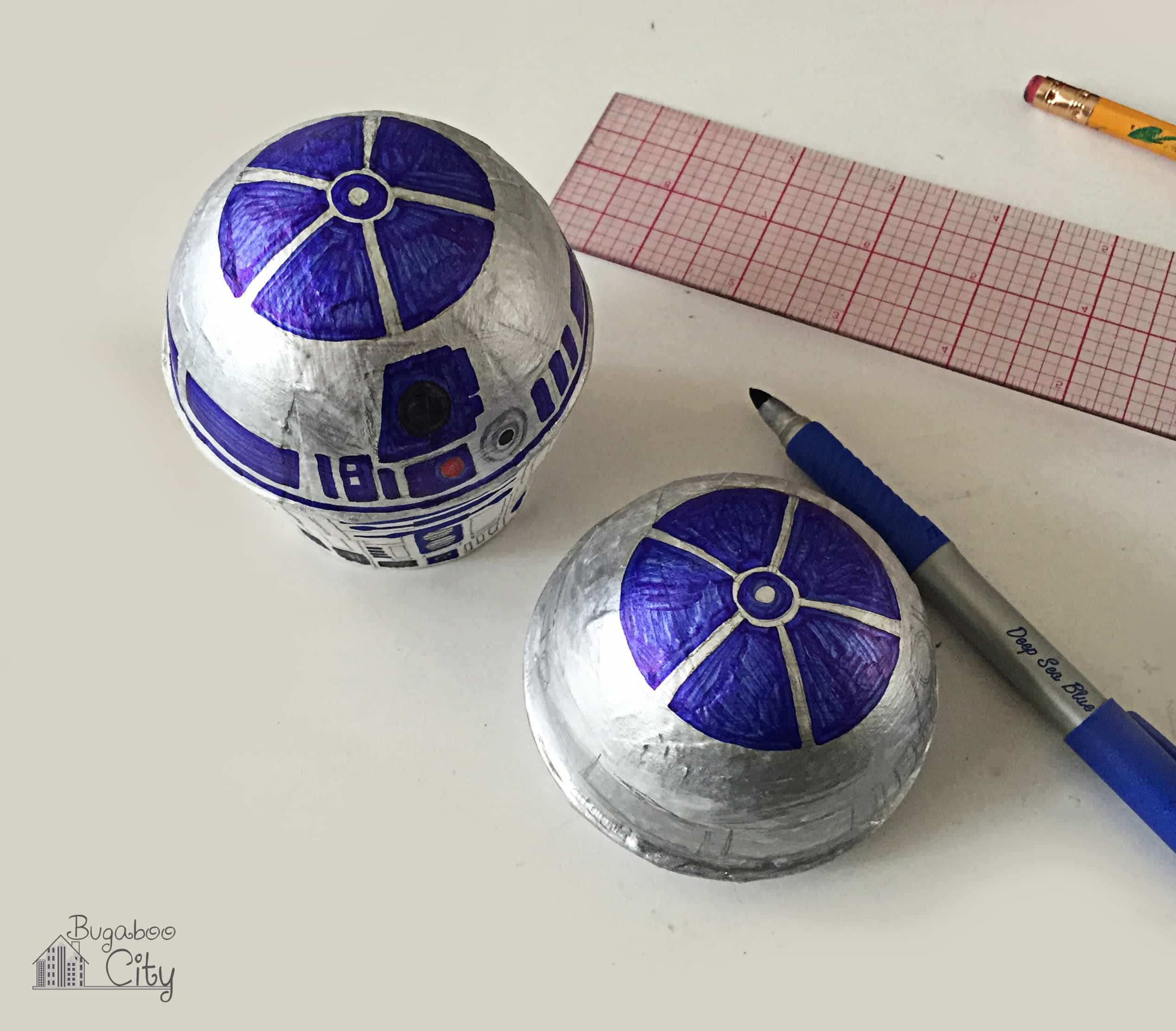 Blue marker is used to color in the details of R2D2 on the box.