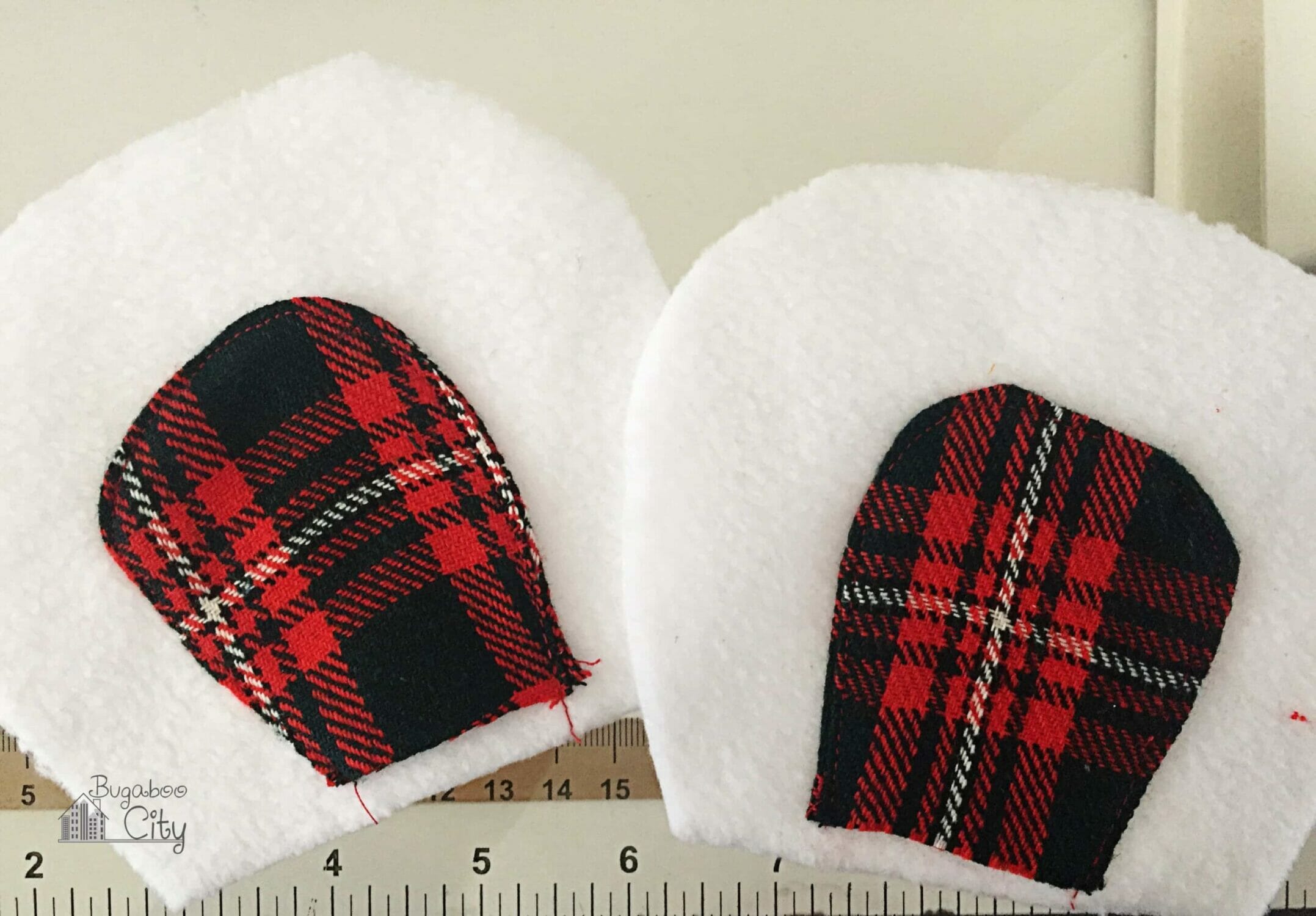 Polar bear ears made from white fleece and red plaid.