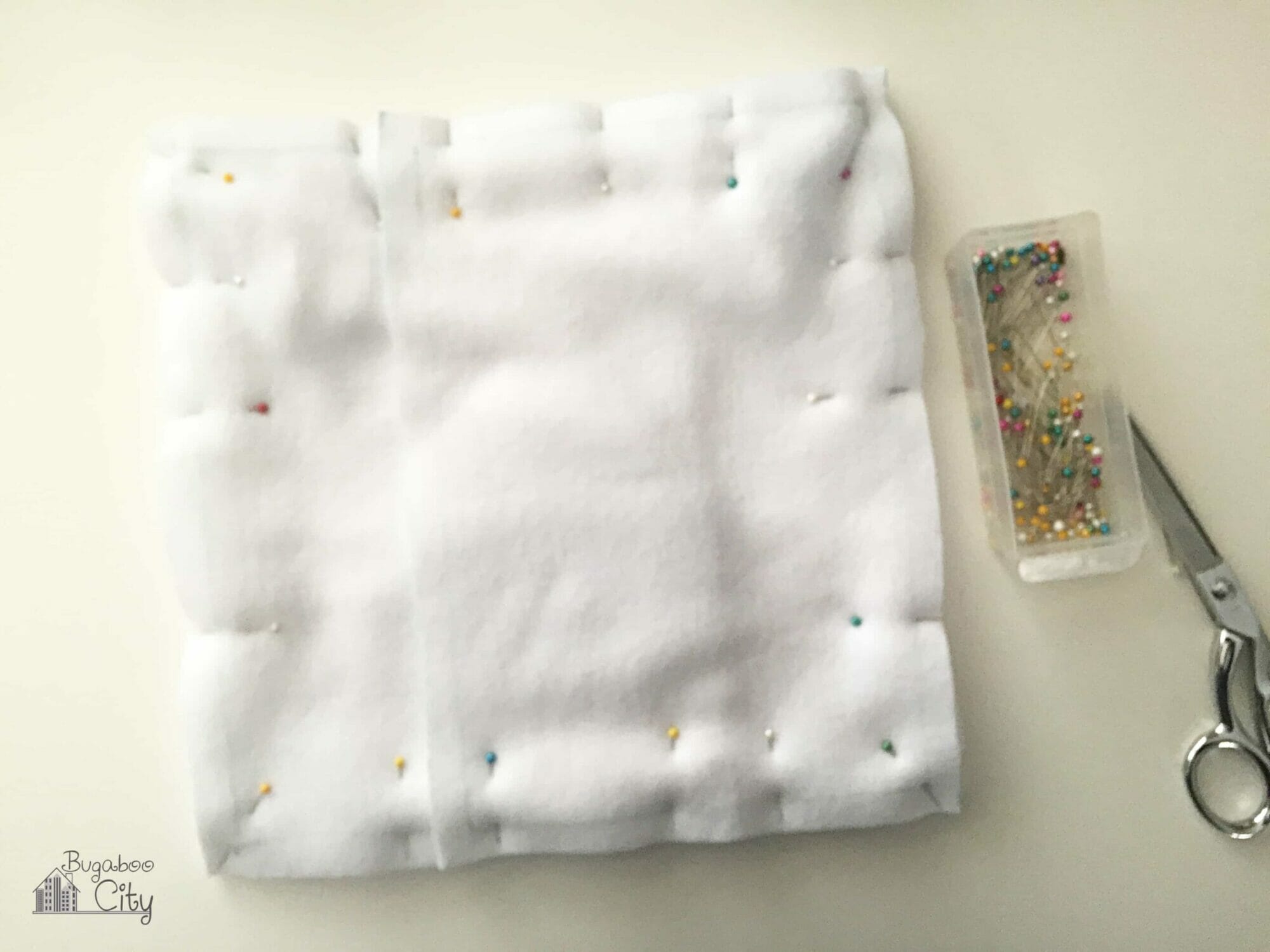 Both back pieces are pinned on top of the polar bear pillow.