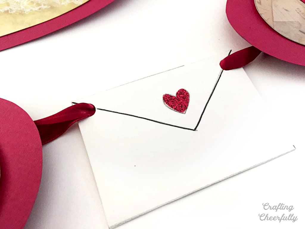 Paper envelope with red glitter heart.