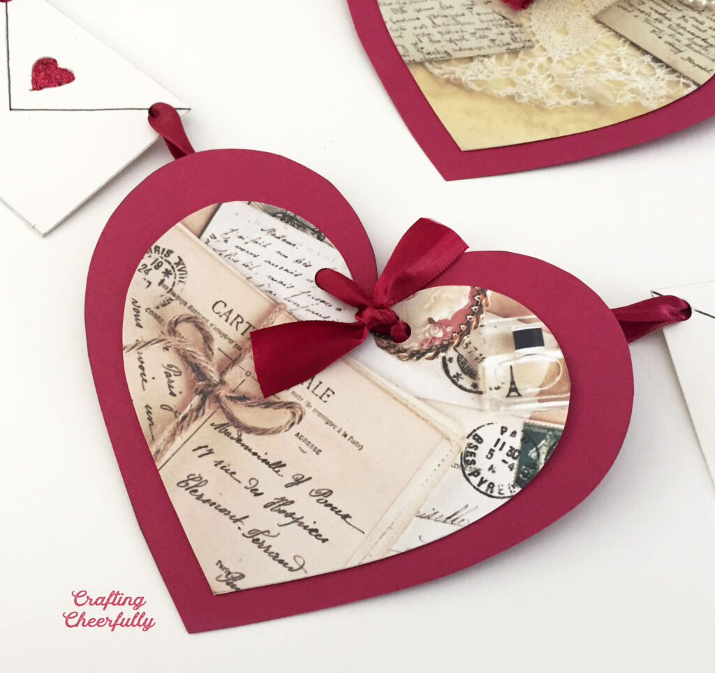 Heart banner with paper hearts decorated with vintage love letters.