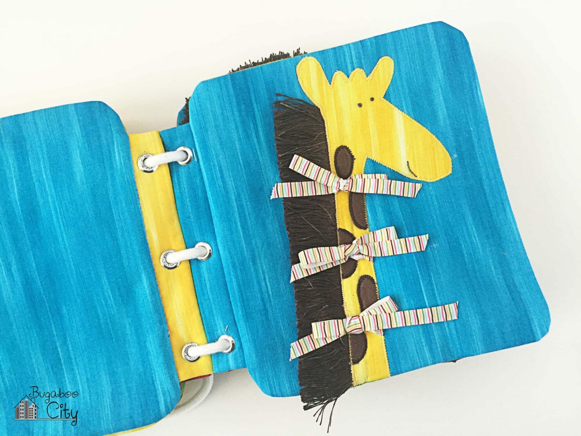 Fabric book page with a cute fabric giraffe with fringe.