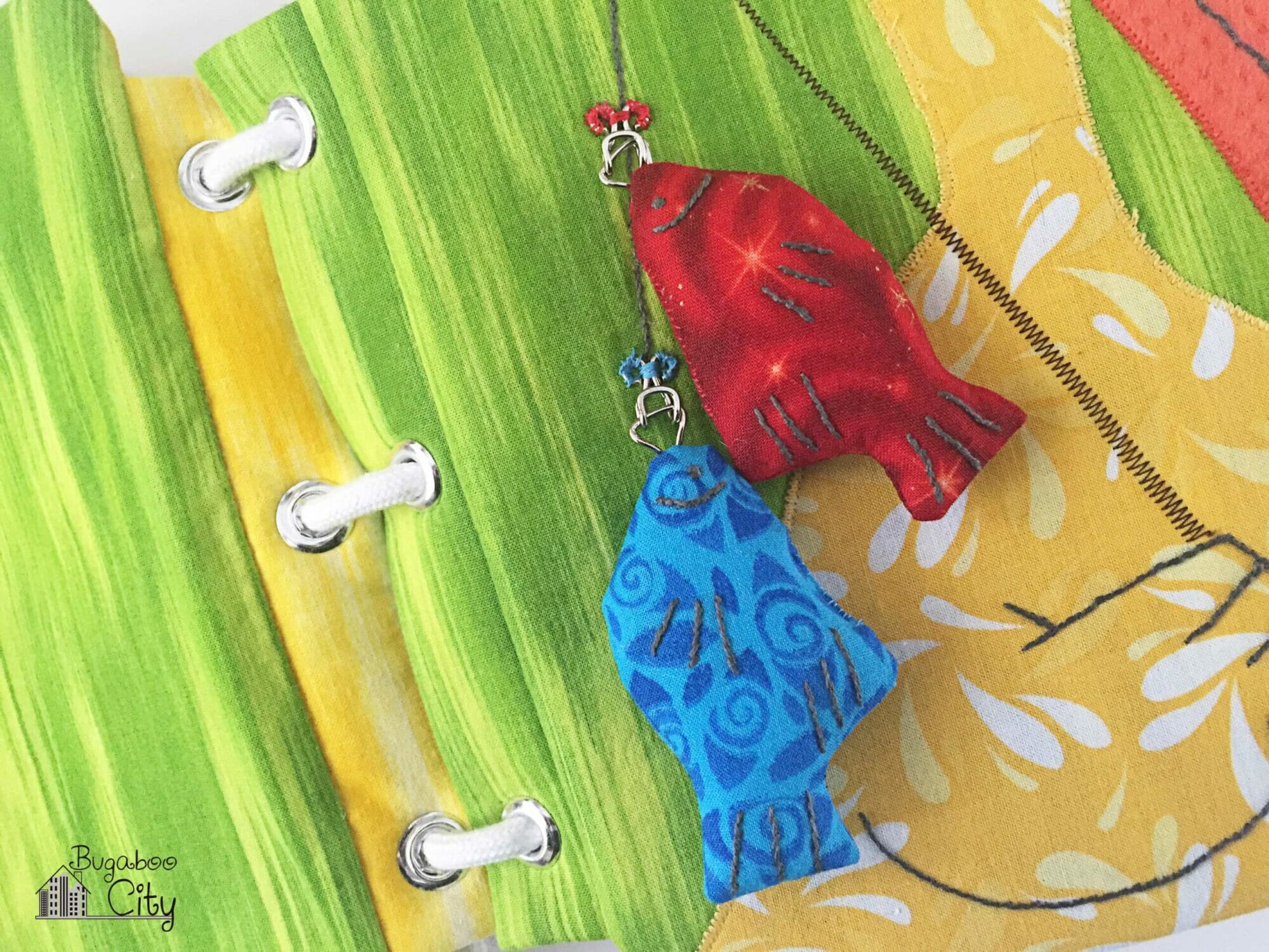 Fabric fish are attached to the pelican's fishing pole with small hook and eye closures.