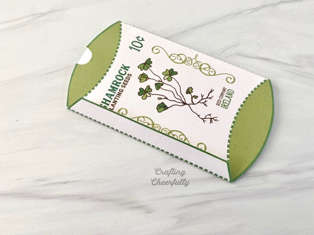 The tab on the printable shamrock box is folded to over.