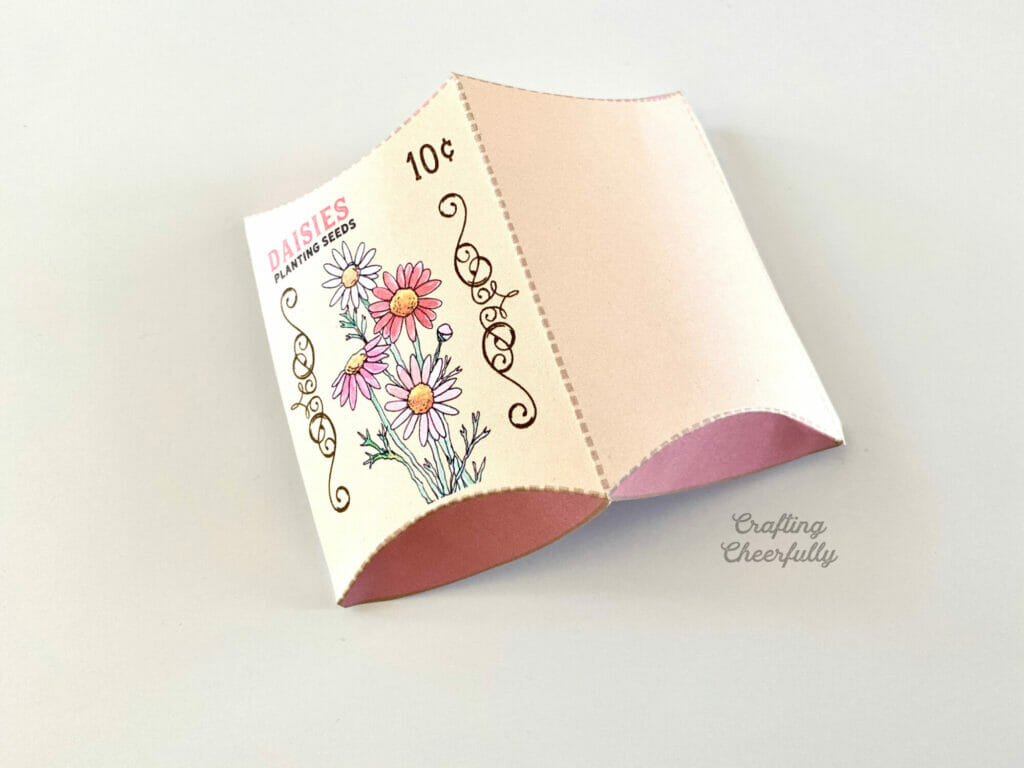 Daisy treat box folded and laying on a white surface.
