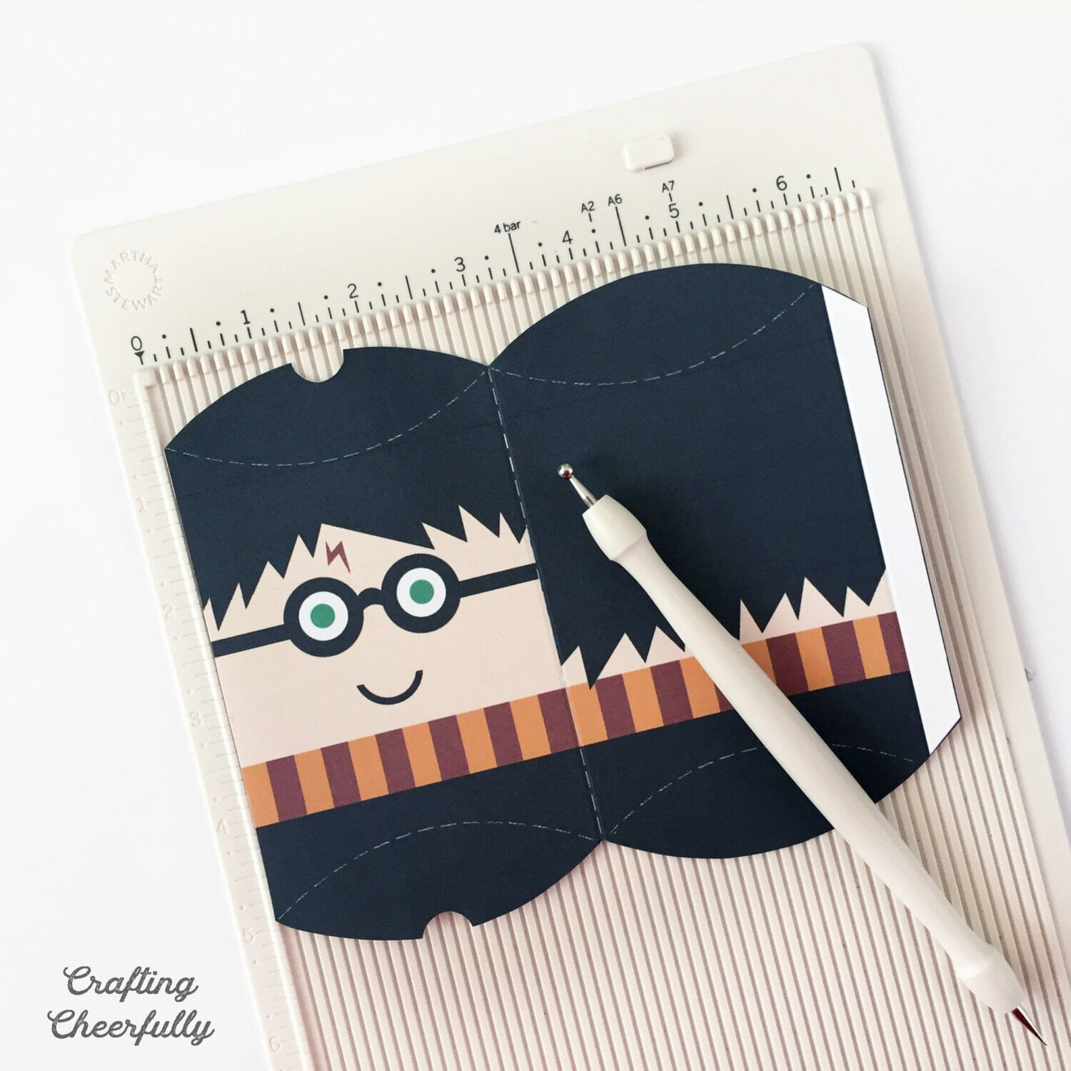Printable Harry Potter treat box lays on a scoring board.