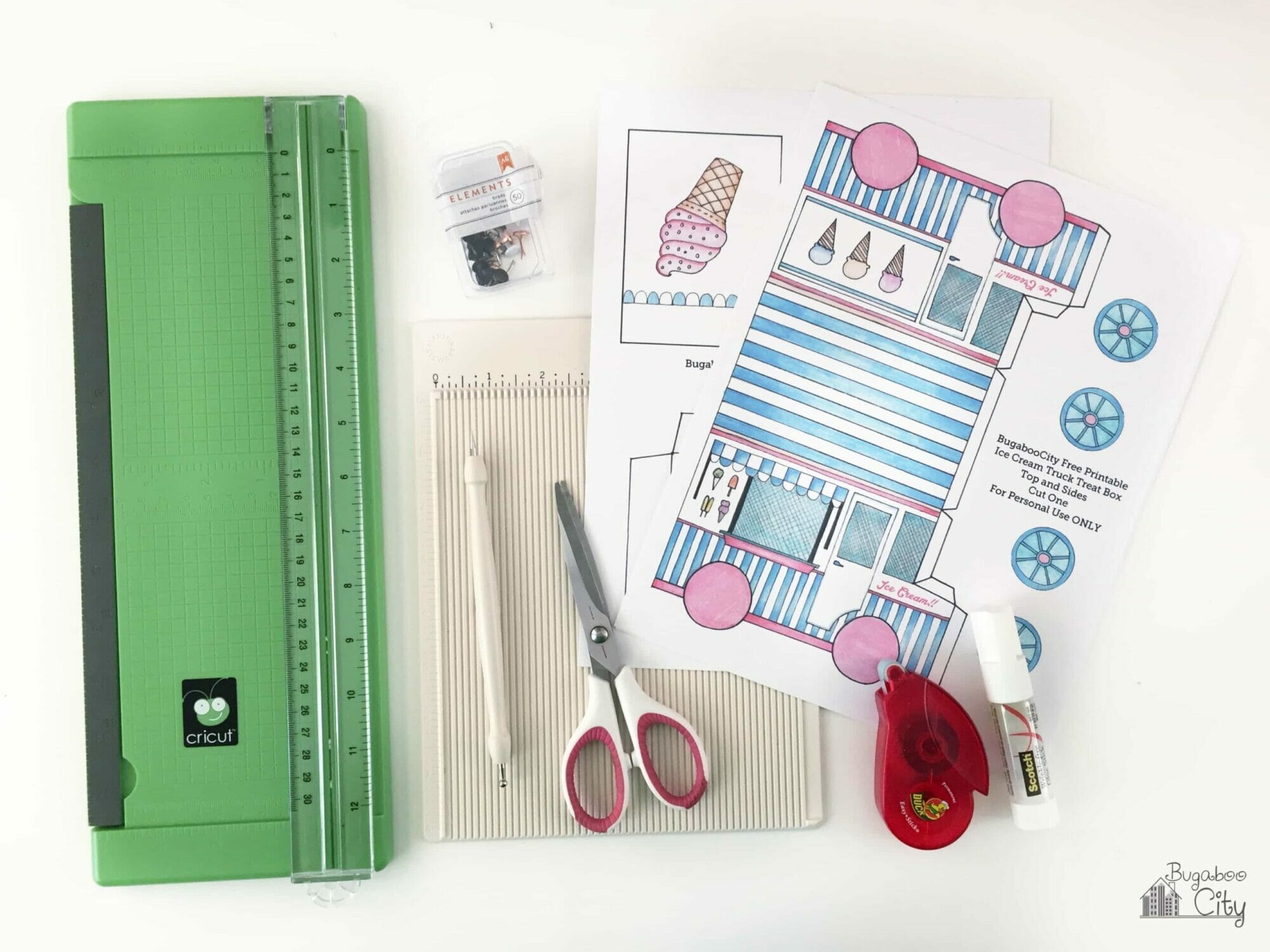 Supplies for ice cream truck treat box including paper trimmer, scissors, scoring board, double-sided tape and printables.
