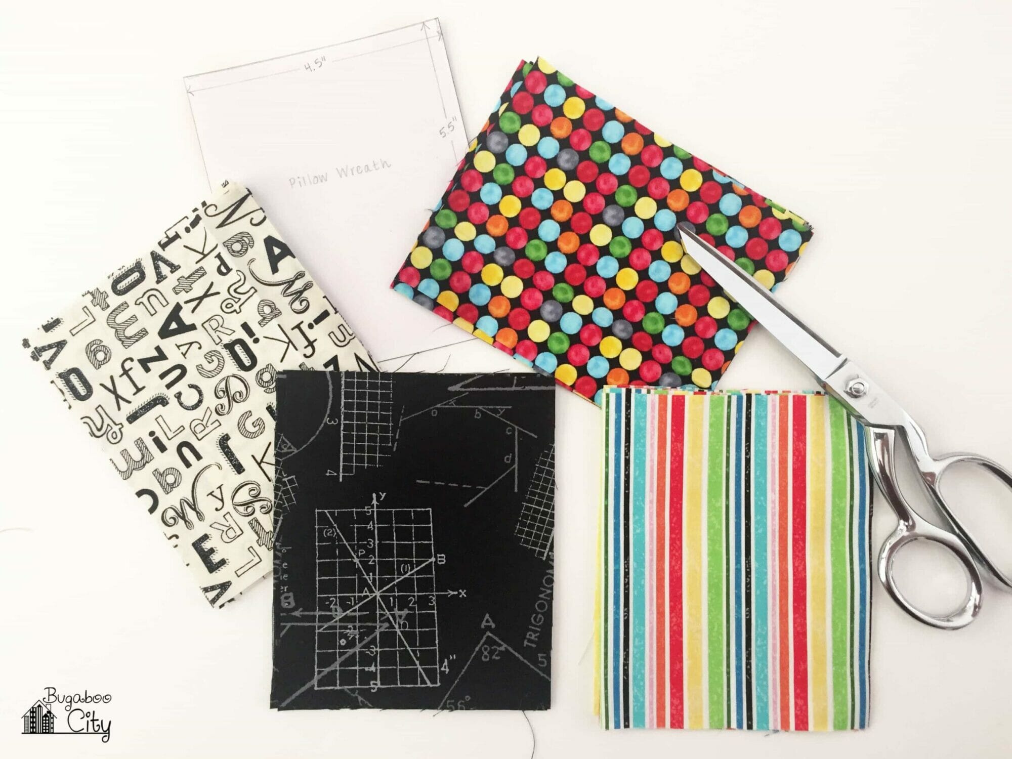 Rectangles of fabric are cut from five different school-themed fabrics.