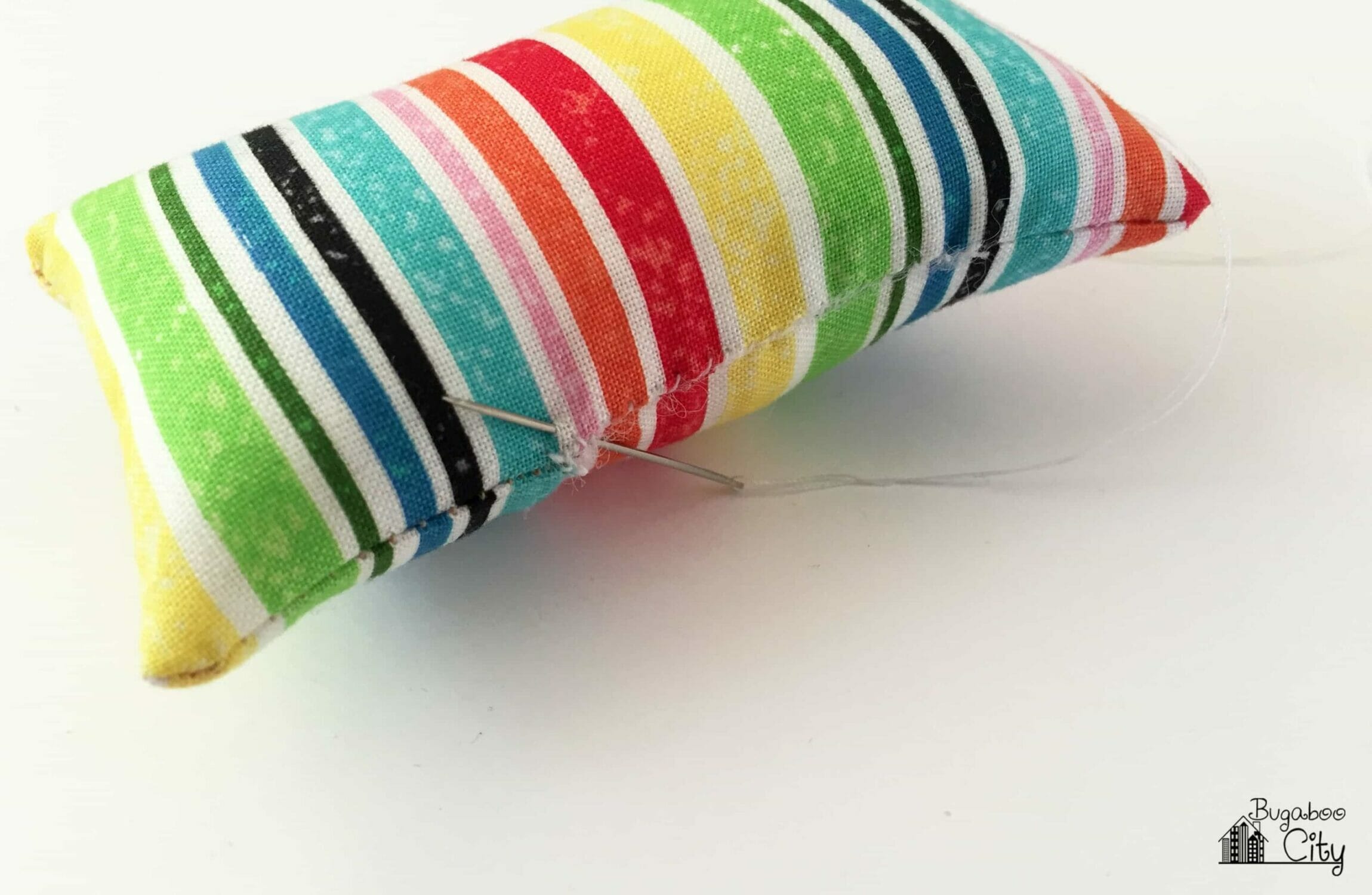 The opening in the side of the pillow is hand stitched closed.