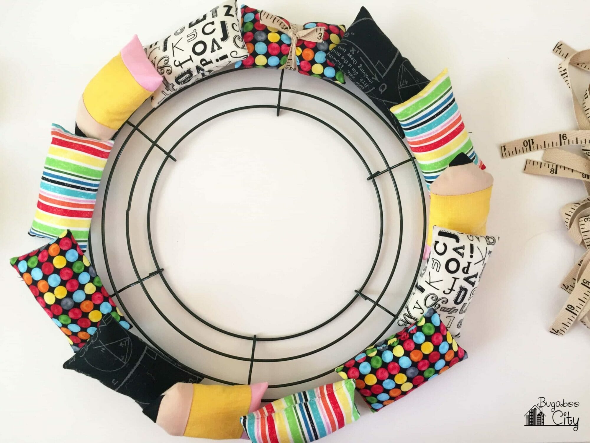 Mini pillows are placed around the edges of the wire wreath frame.