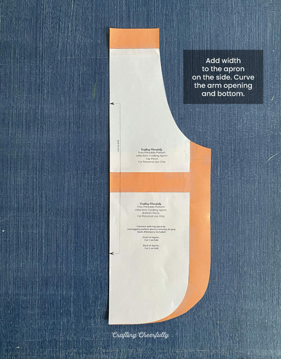A paper apron pattern lays on a blue surface. 