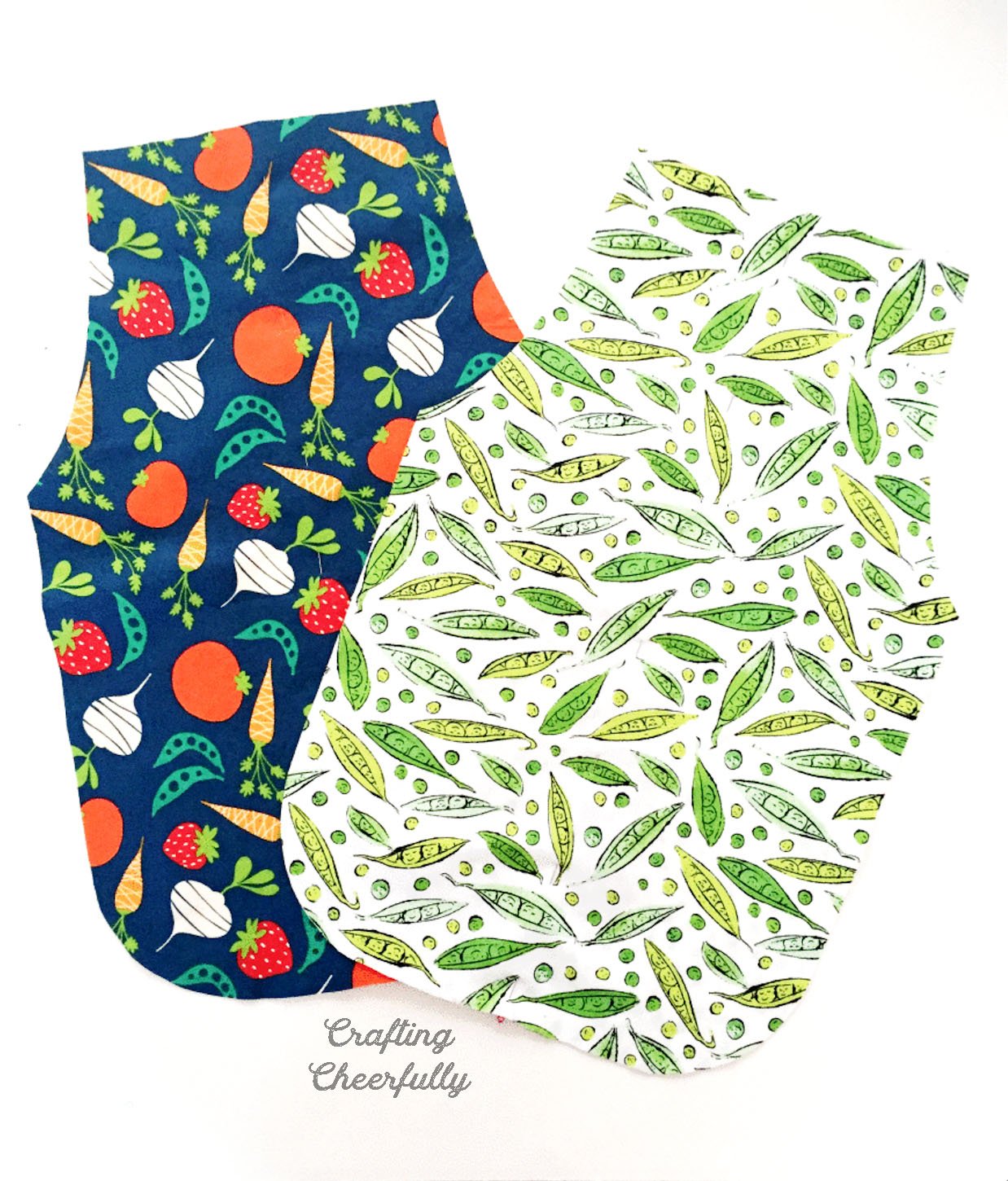 Fabric is cut using apron pattern for two aprons that lay side by side.