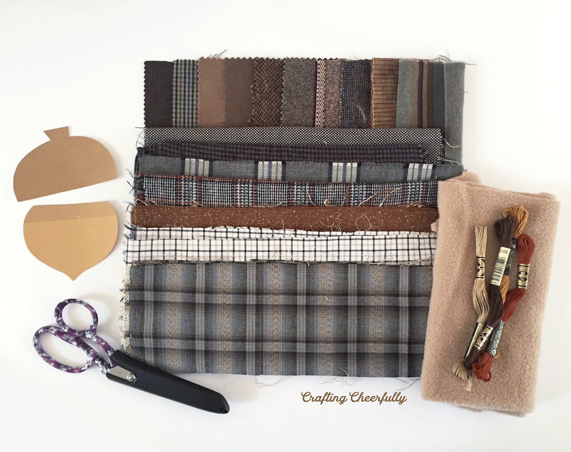 Wool fabric scraps, scissors, acorn template, embroidery floss and fleece.