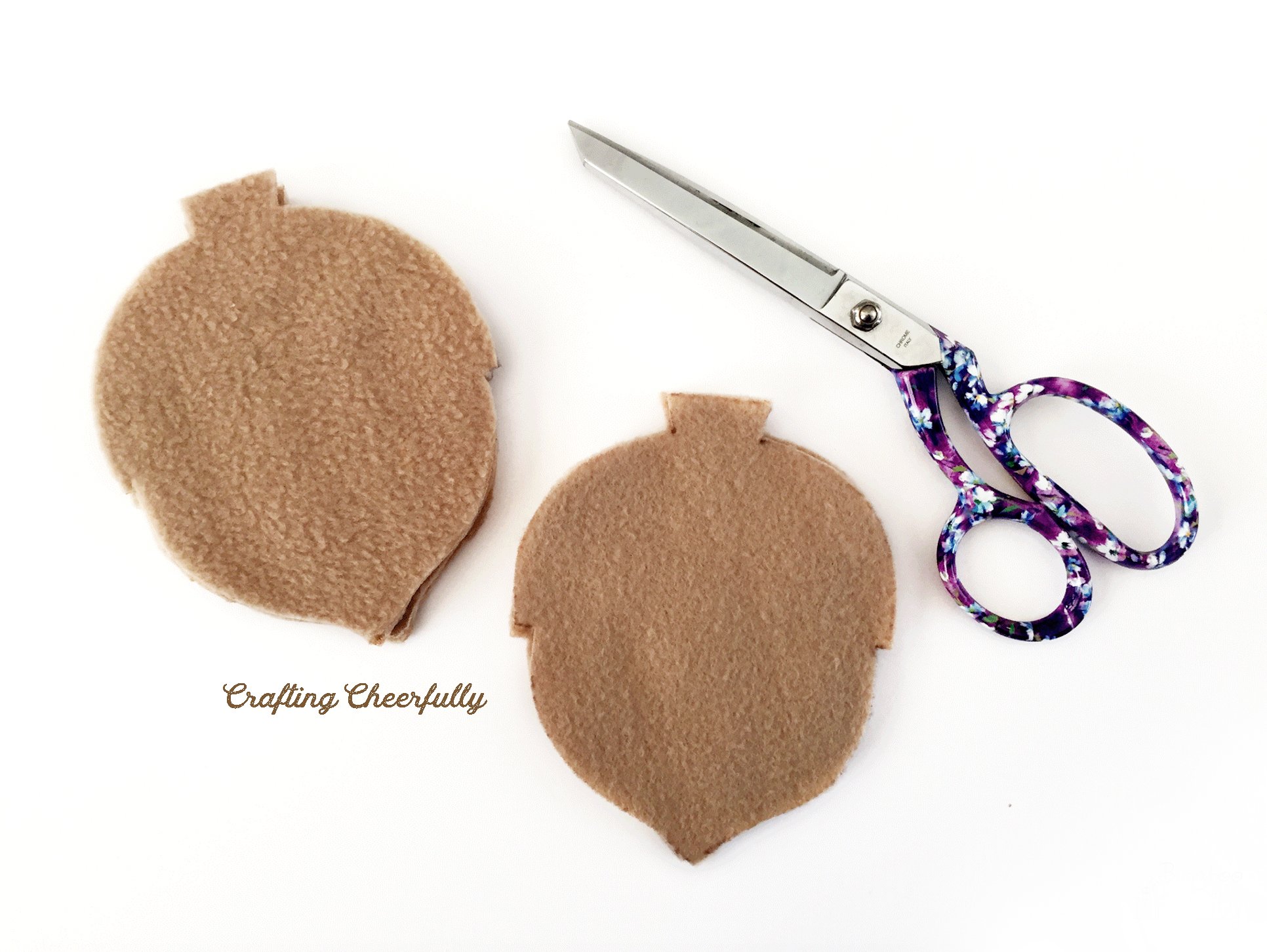 Tan fleece acorns are cut and stacked together.