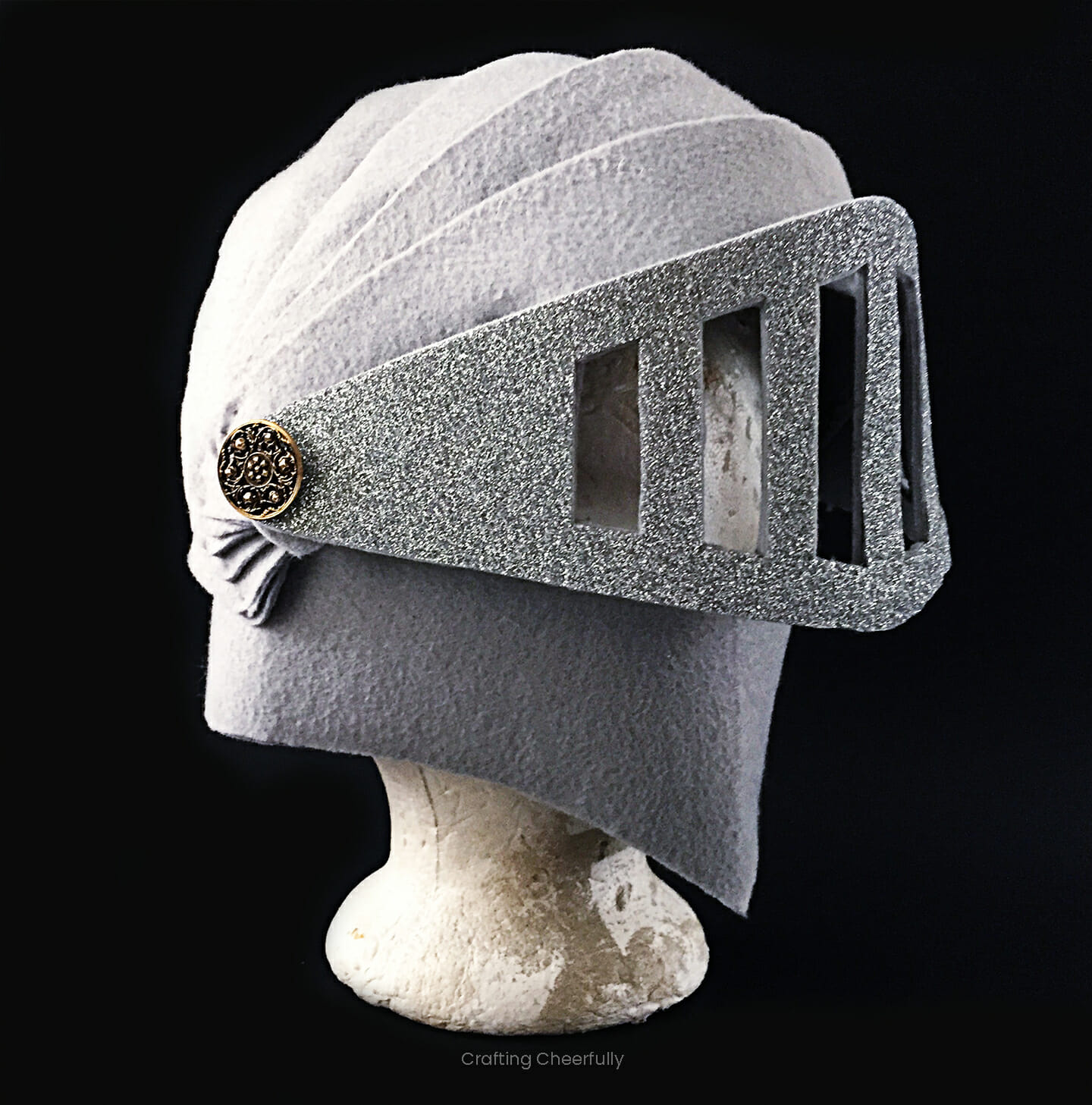 Knight helmet made from gray felt with a silver glitter face shield.