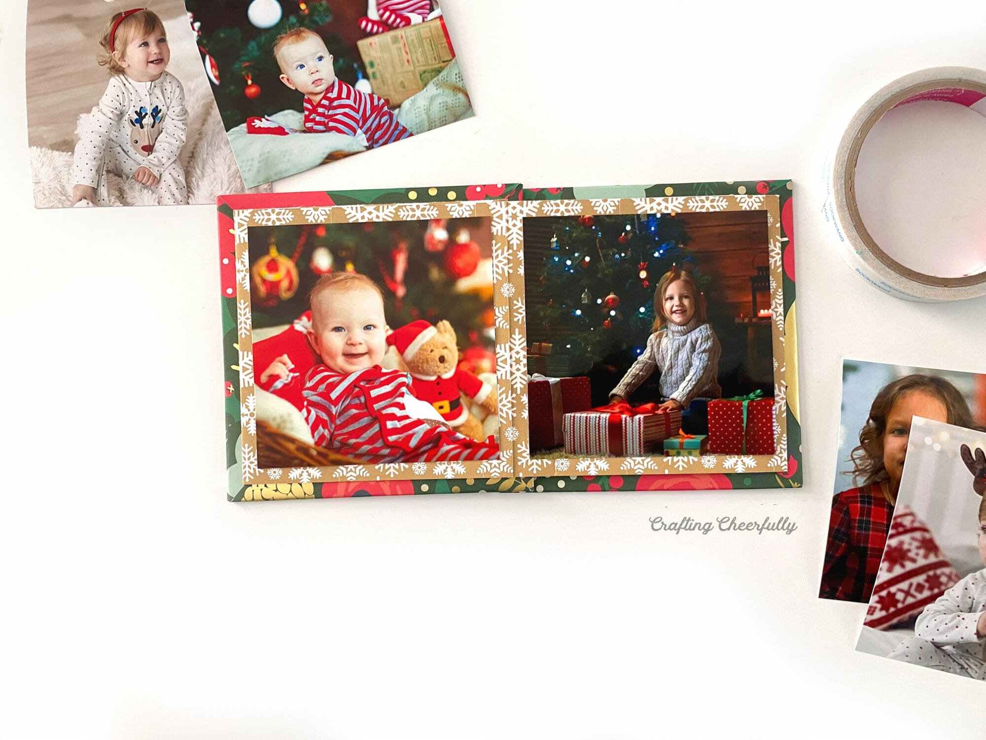 Holiday photo album lays on a white table.