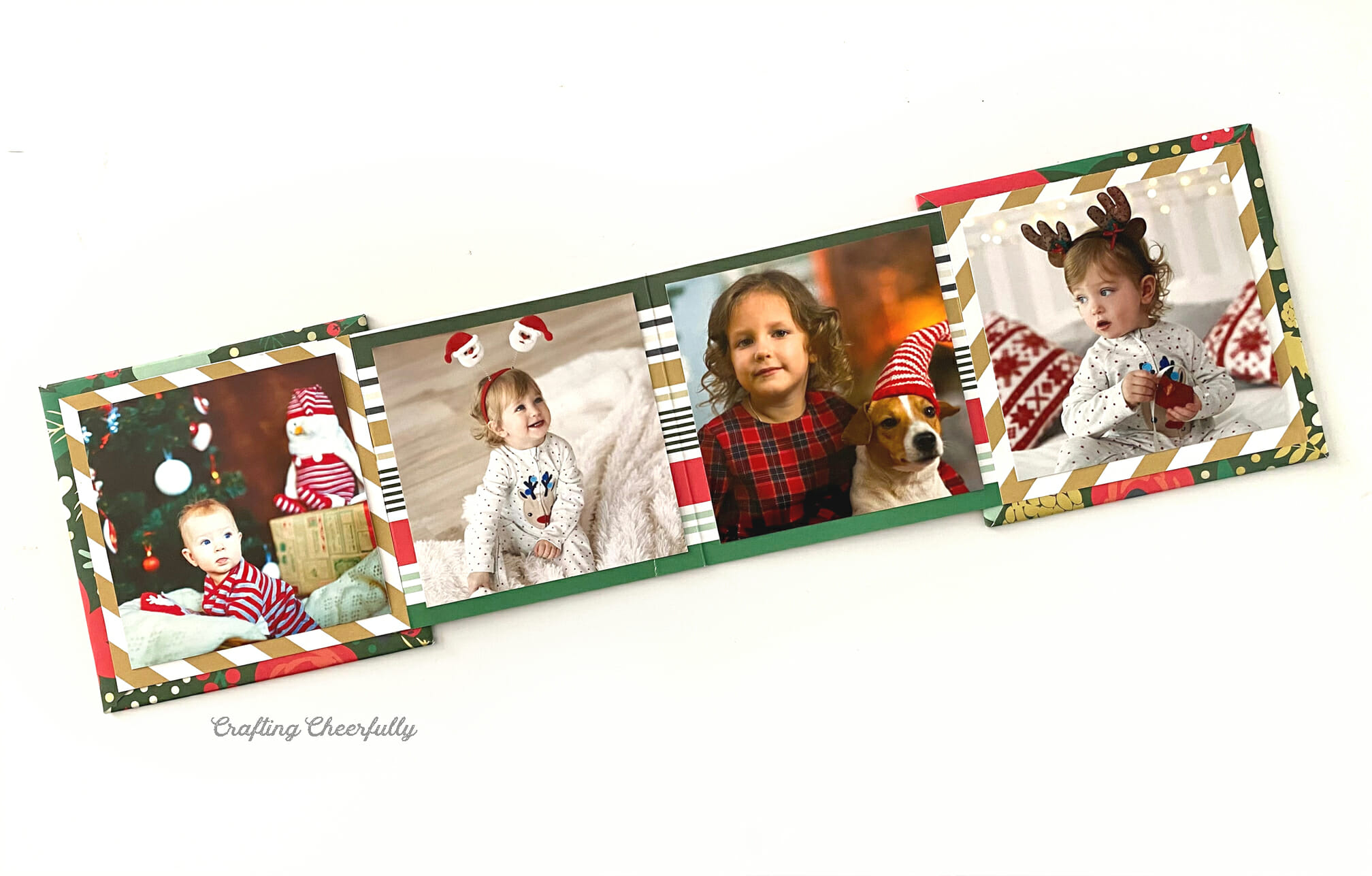 Holiday photo album lays open on a white table.