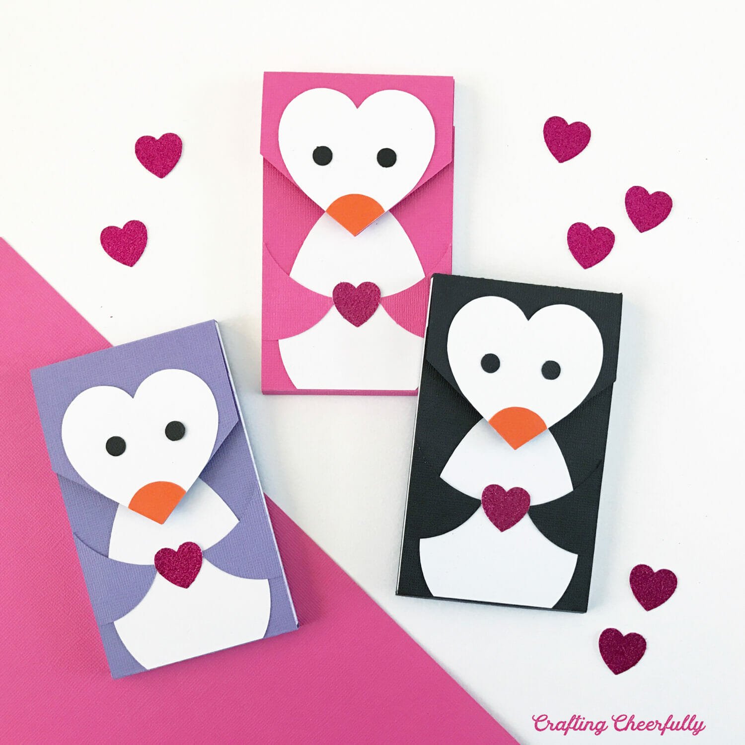 Valentine's Day Penguin notepads; one is purple, pink and black.