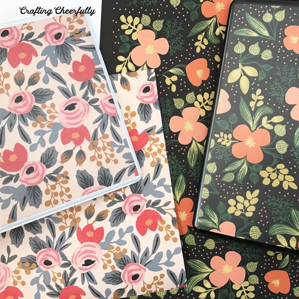 Two binders covered with floral paper.
