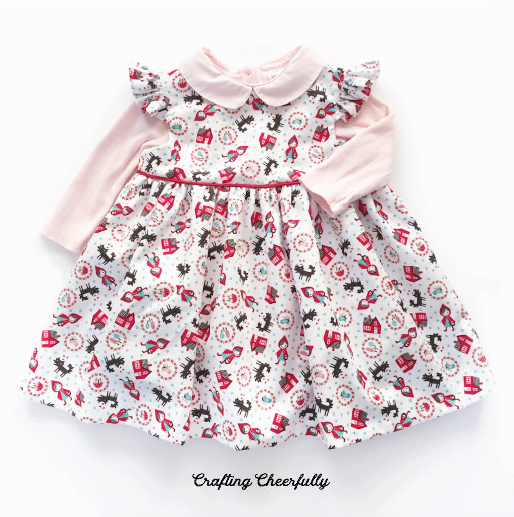 Little Red Riding Hood baby dress with pink onesie.