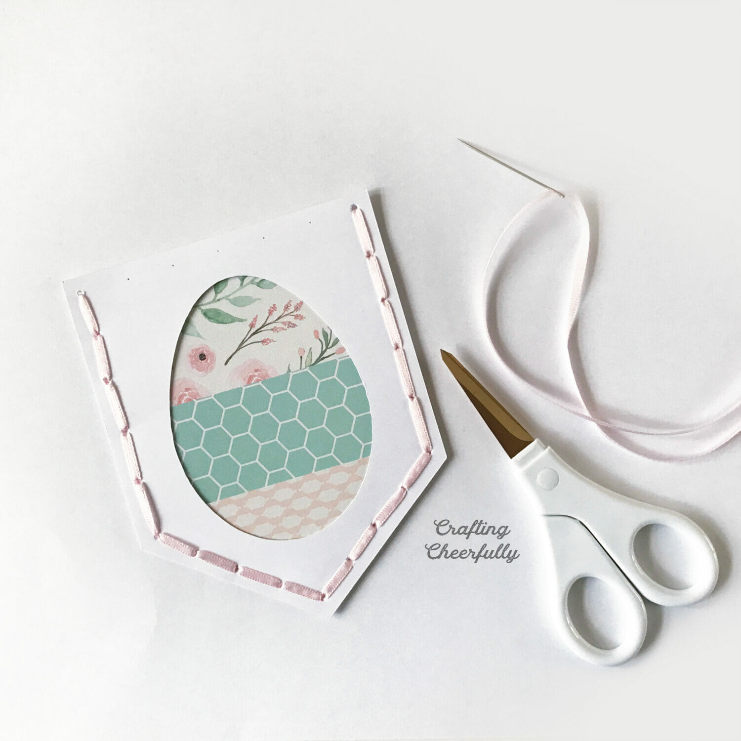 Easter egg pennant is stitched with thin pink ribbon on four sides; the top side is not stitched.