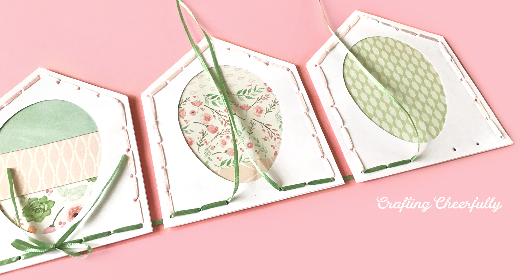Pennants are strung together with thin green ribbon; green bows are tied in the middle of each pennant.