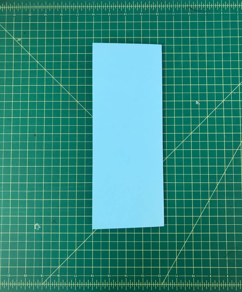 A blue sheet of paper folded in half lengthwise.