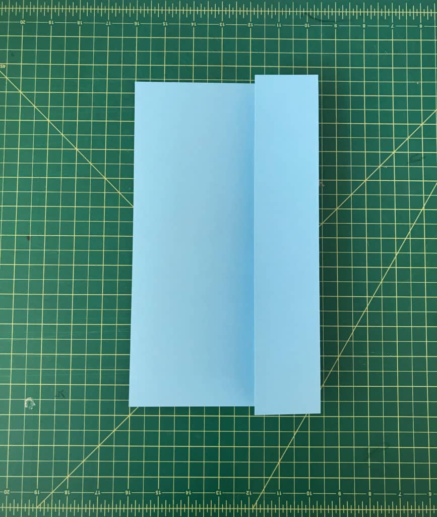 Blue sheet of paper opened up and the right side folded to the center.