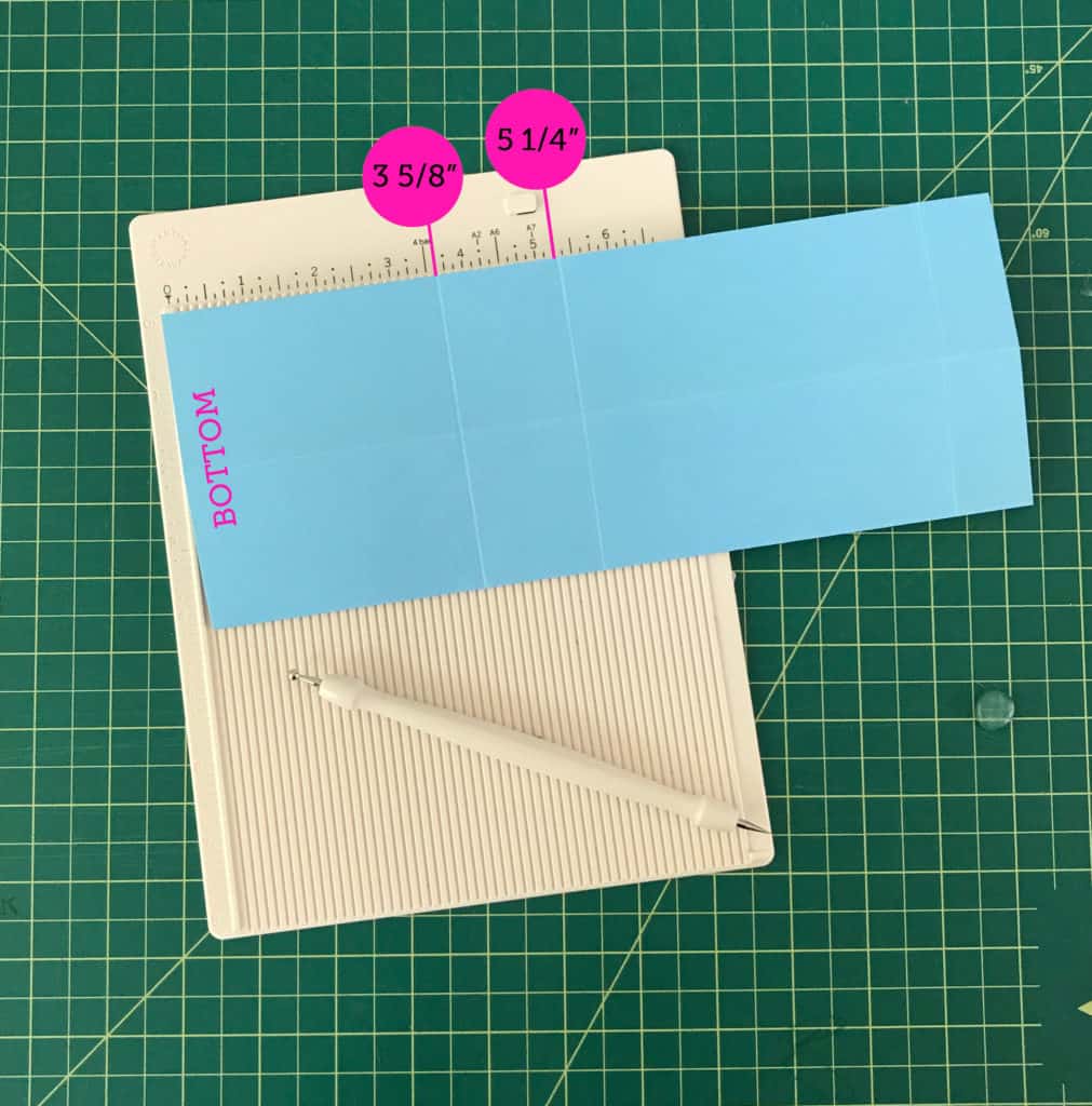 A blue sheet of paper scored 3 5/8" and 5 1/4" up from the bottom.