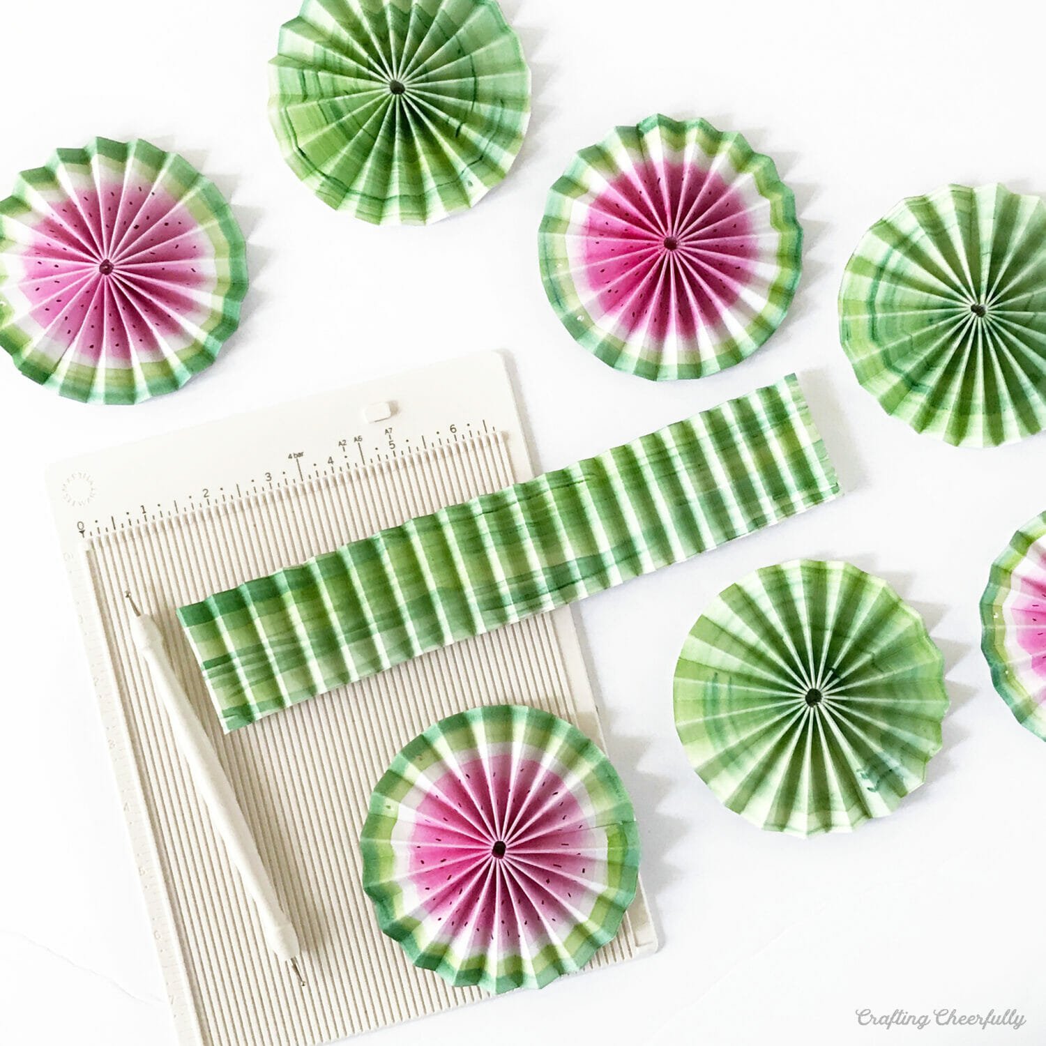 Watermelon paper medallions lay next to a scoring board.