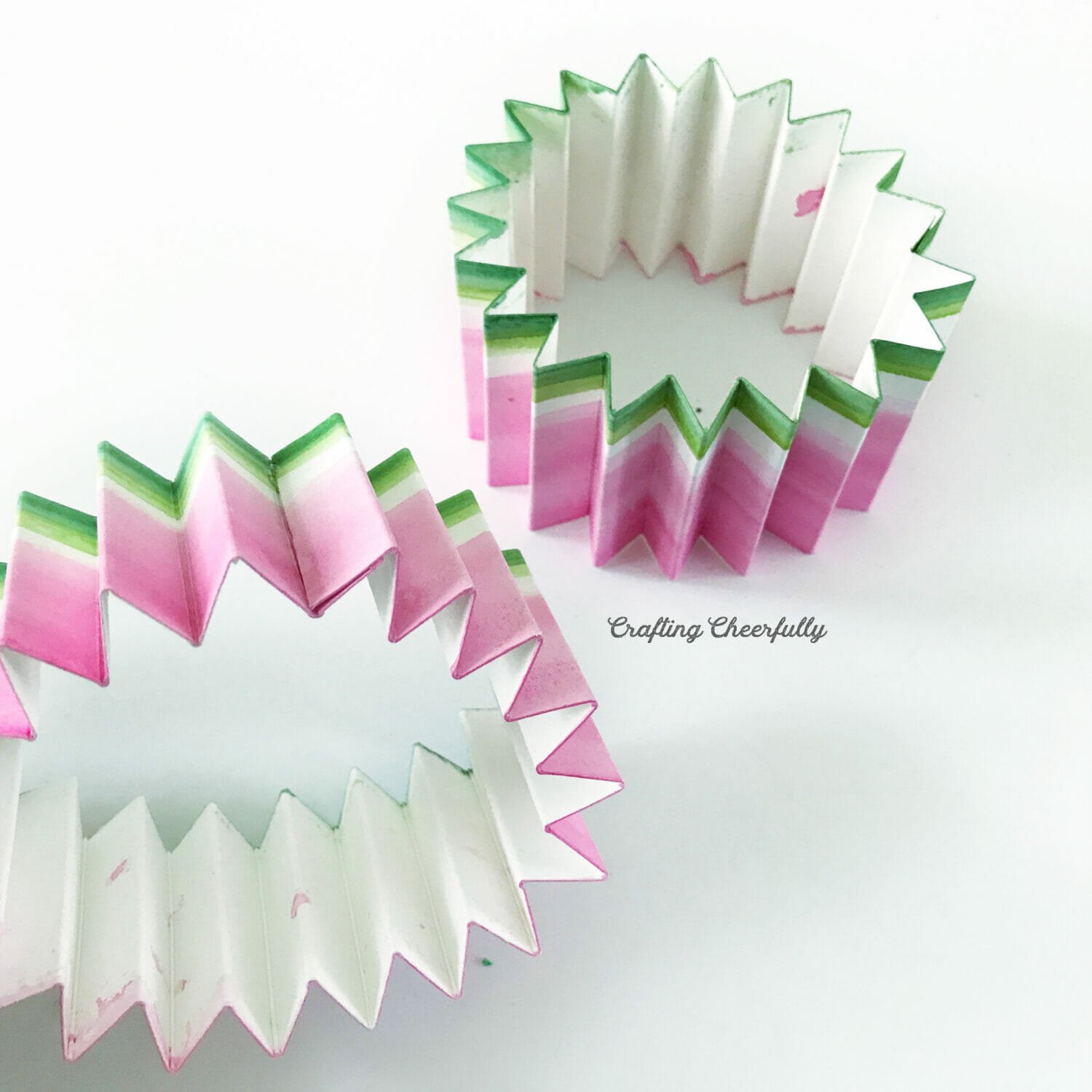 The strips of accordion paper are turned into loops.
